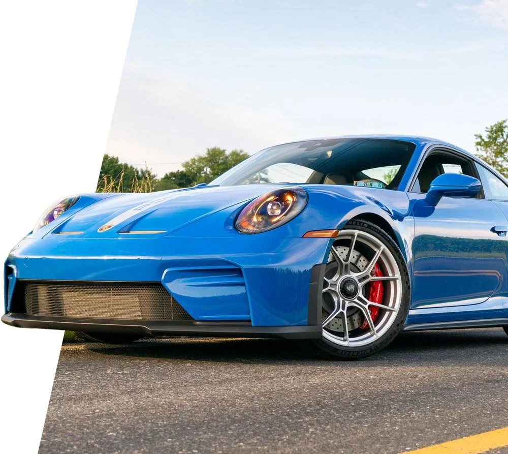 A blue Porsche 911 GT3 touring being professionally photographed by KennanR before going live on Cars&Bids to be auctioned with professional car auction consignment services
