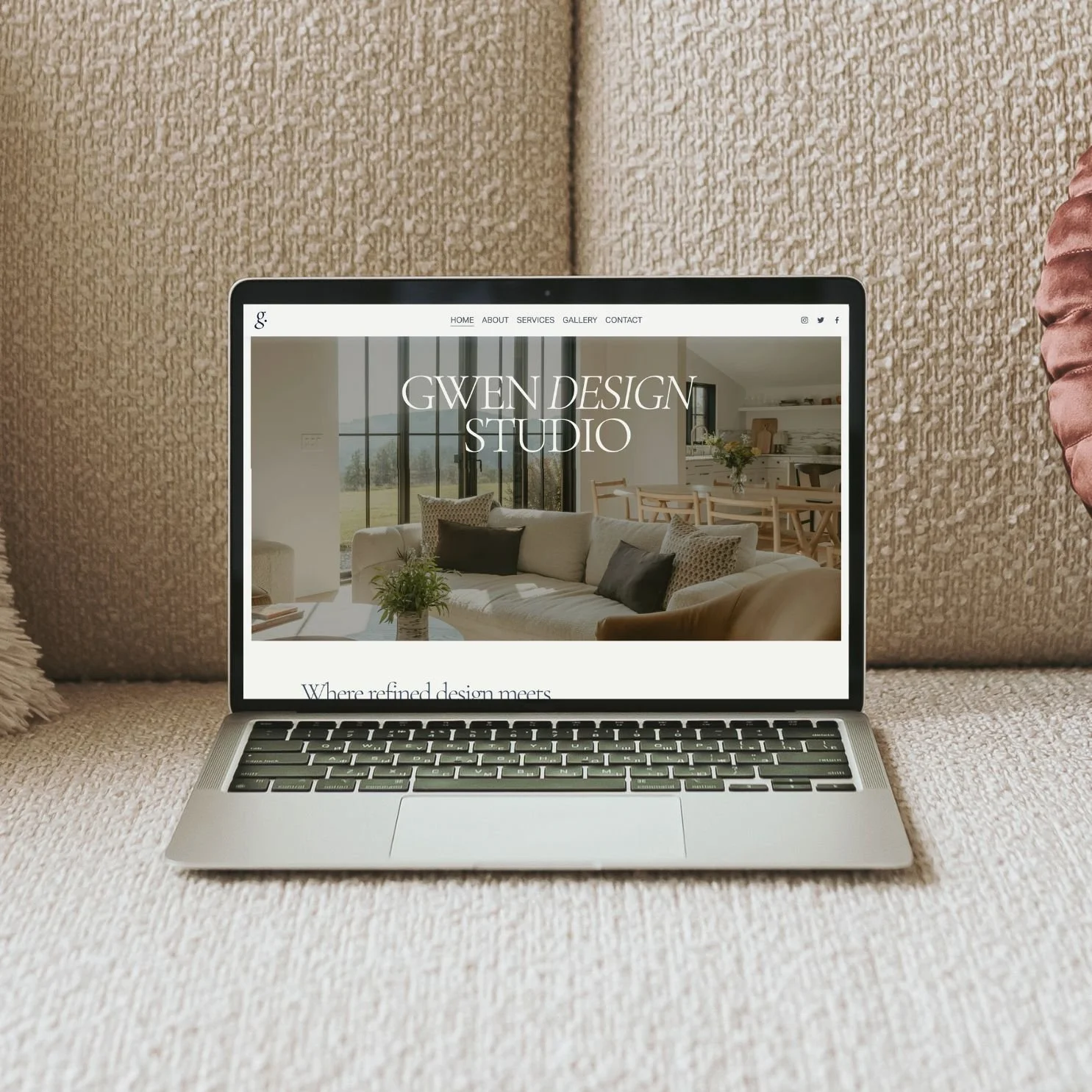 Open laptop on a beige couch displaying a home design website titled 'Gwen Design Studio'.