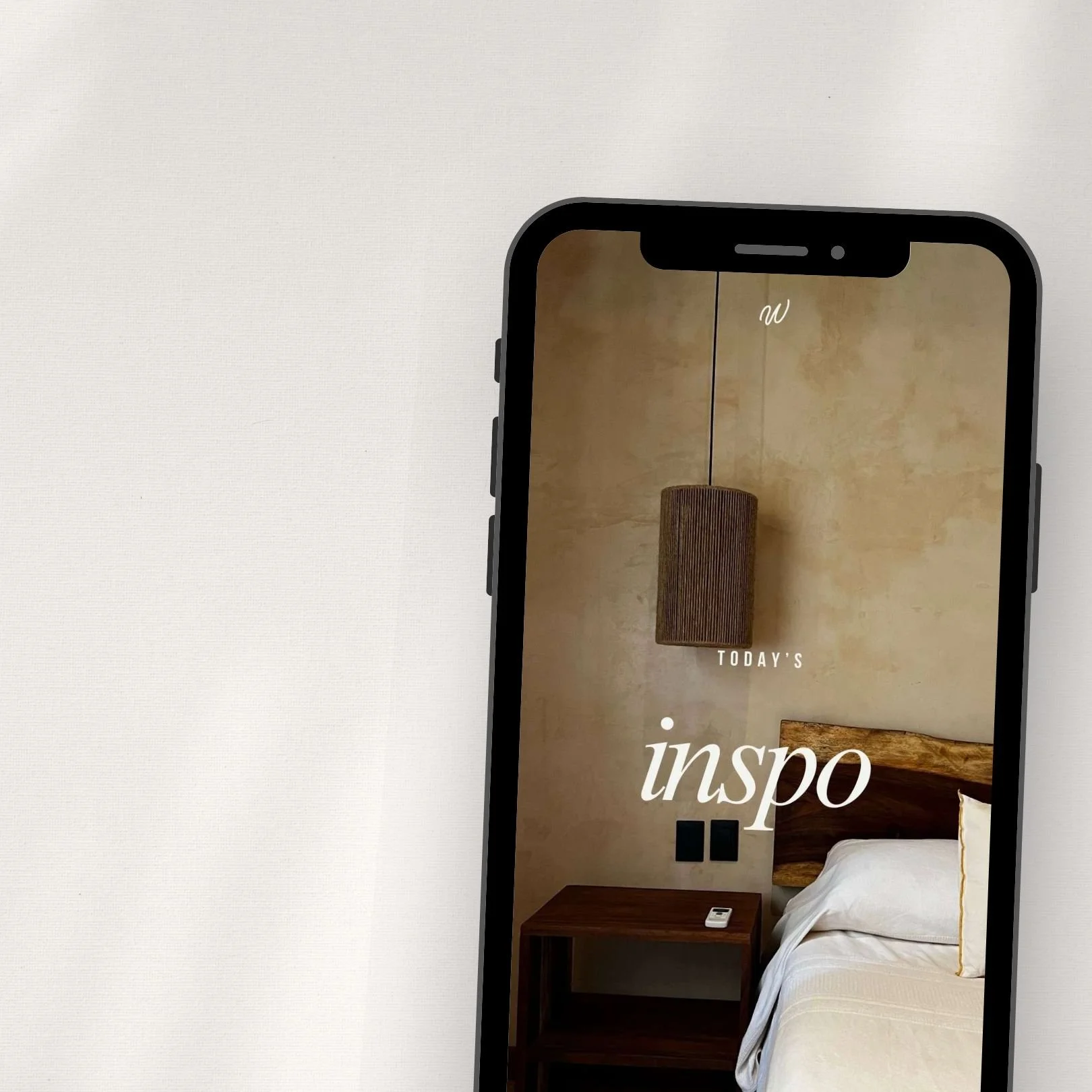 Smartphone screen displaying a hotel room decor photo with a hanging light fixture, a wooden headboard, and a nightstand with a remote, with overlaid text 'Today's inspo'.