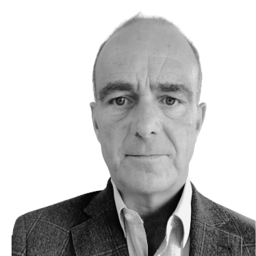 Black and white close-up portrait of a middle-aged man with short hair, wearing a collared shirt and blazer.