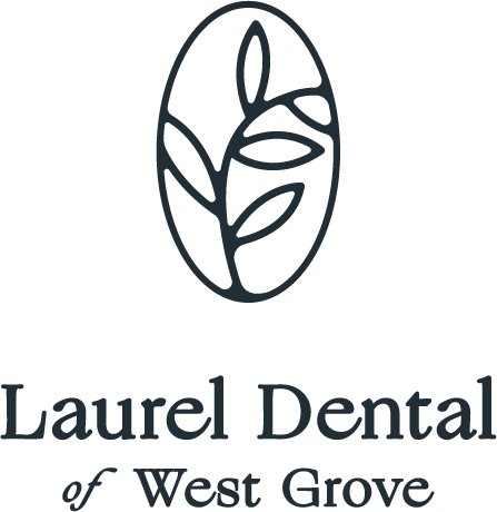Logo for Laurel Dental of West Grove featuring an abstract leaf design inside an oval shape.