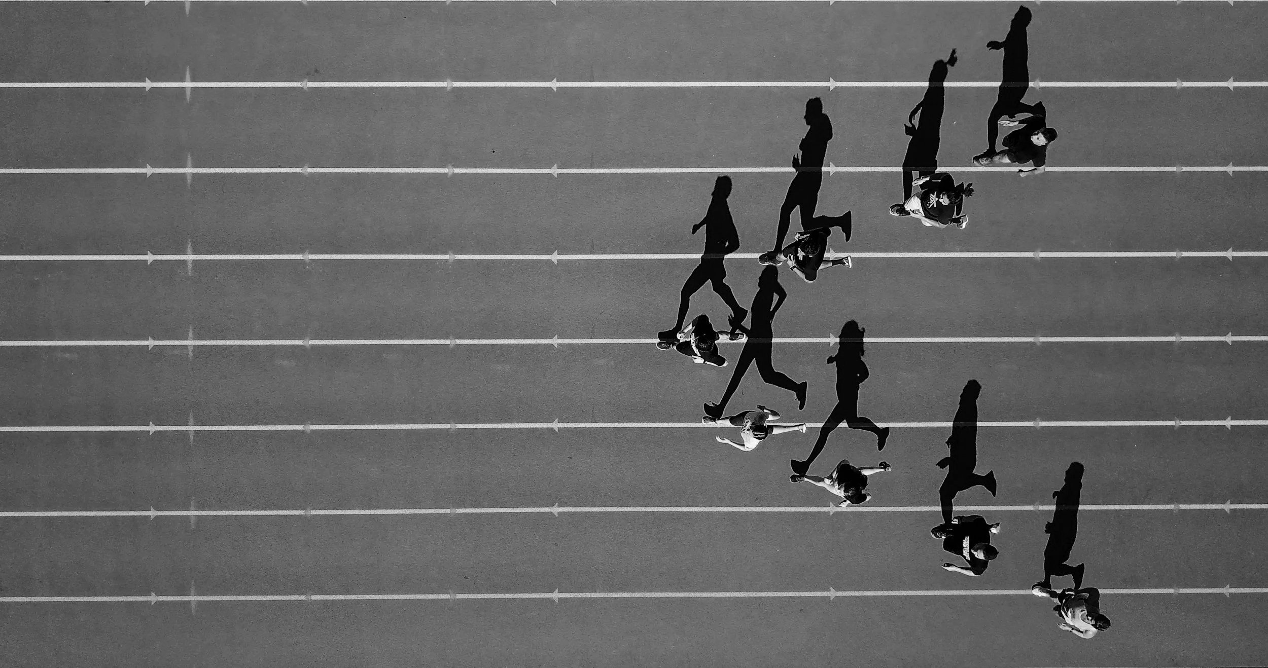 People running freely outdoors on a sunny day, representing active lifestyle recovery after physiotherapy treatment.