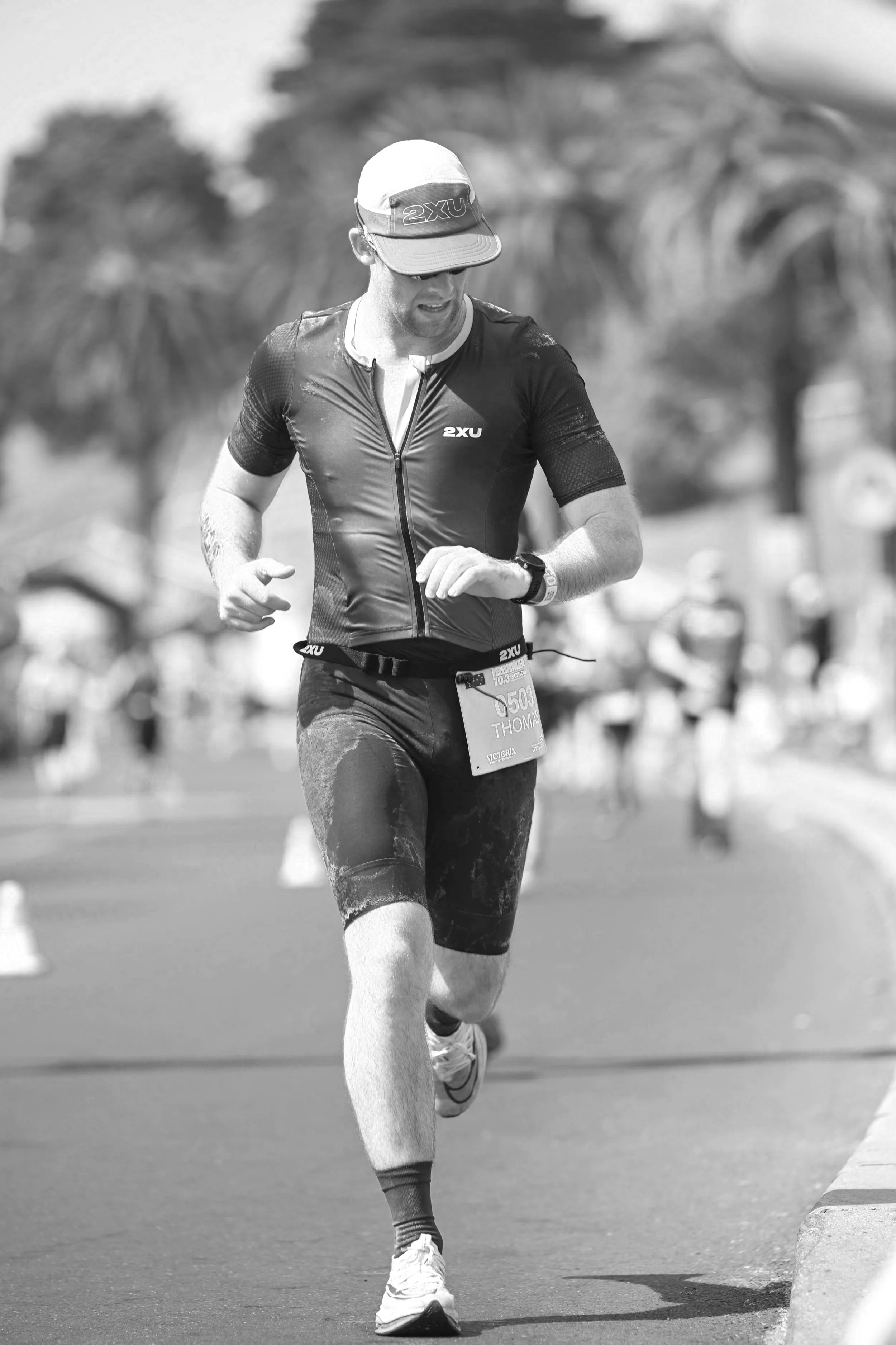 A runner during a ironman 70.3 checking their time.