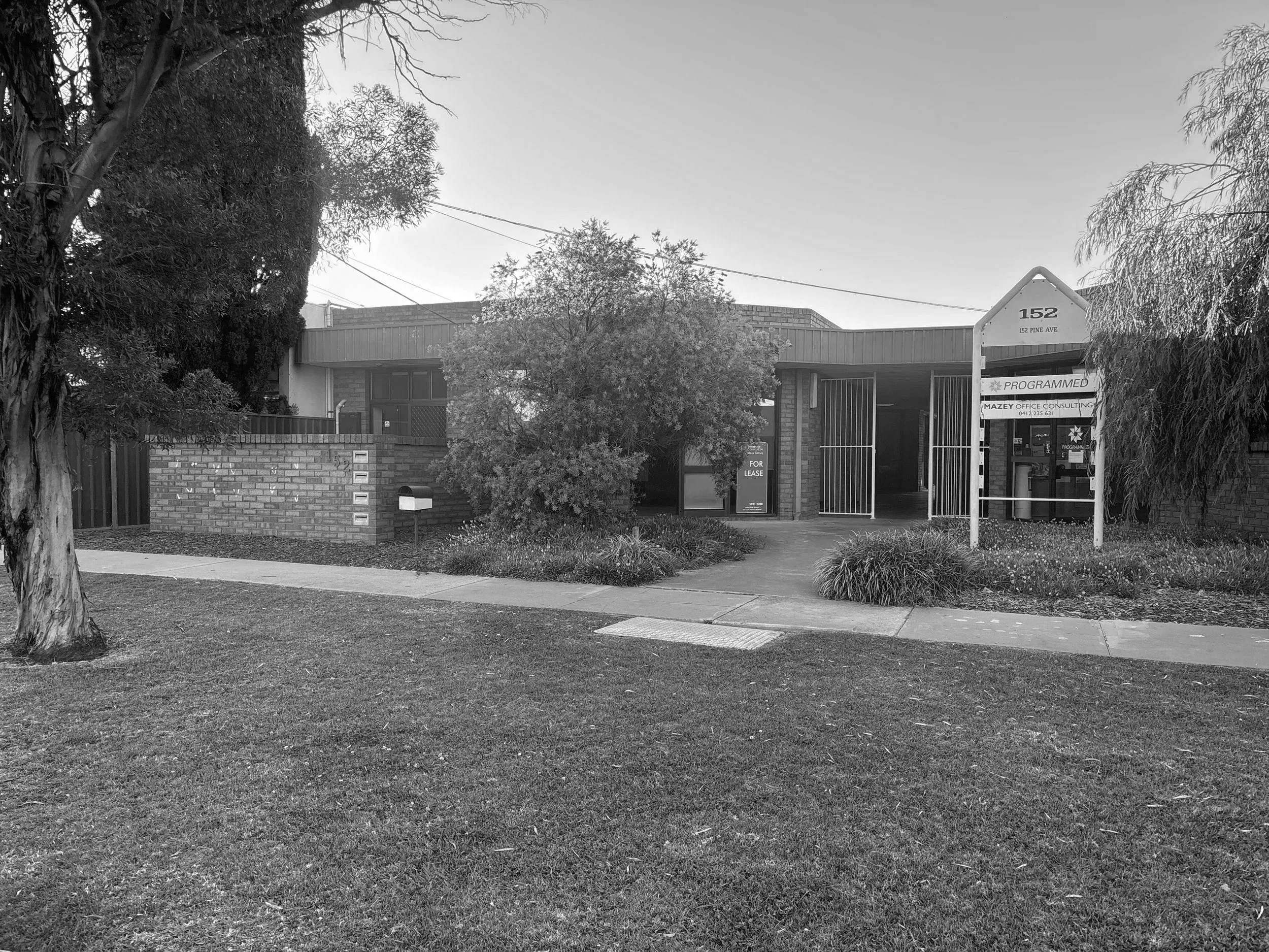 The front entrance and building exterior of the Whitehouse Physiotherapy clinic, featuring accessible parking.