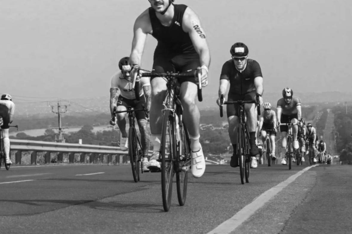 A rider on their bike during an ironman 70.3 in the middle of a pack of other riders