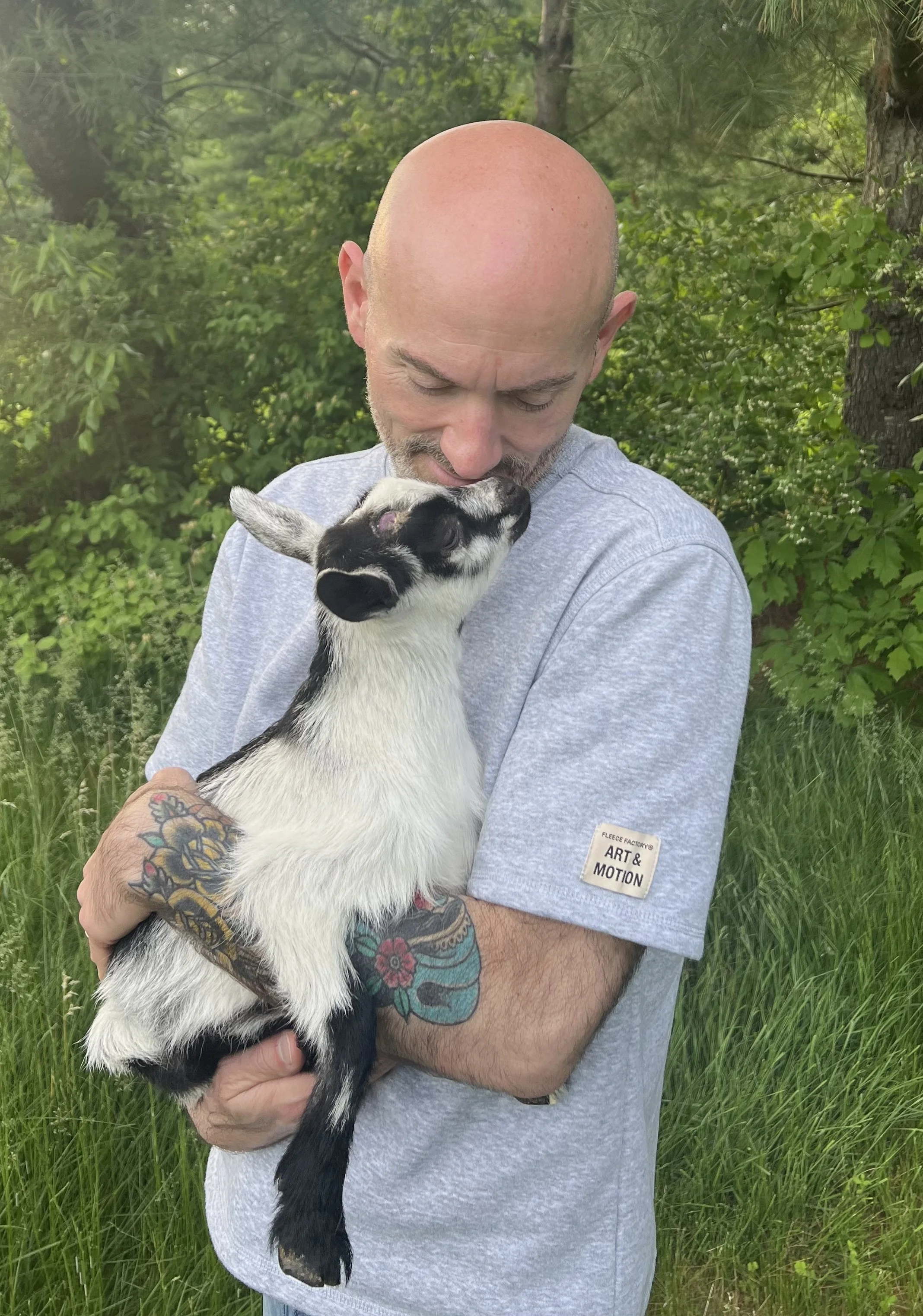 Holding a Nigerian Dwarf goat kid at Saltmark Farm in Windham, Maine.
