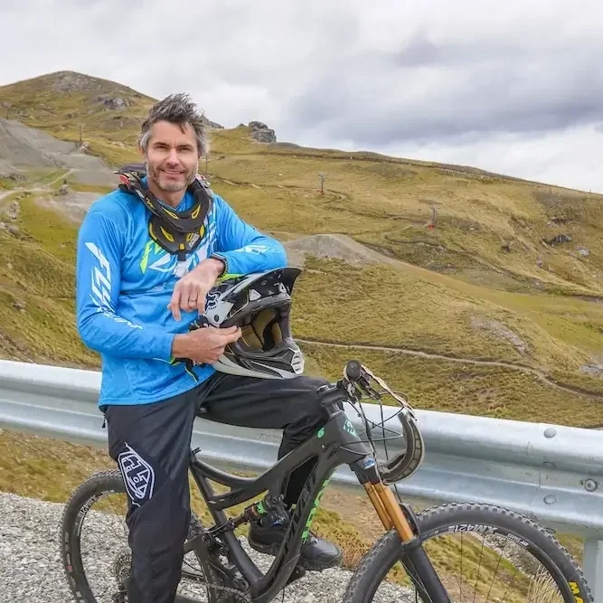 Mick wearing mountain bike gear on a mountain bike at Cardrona