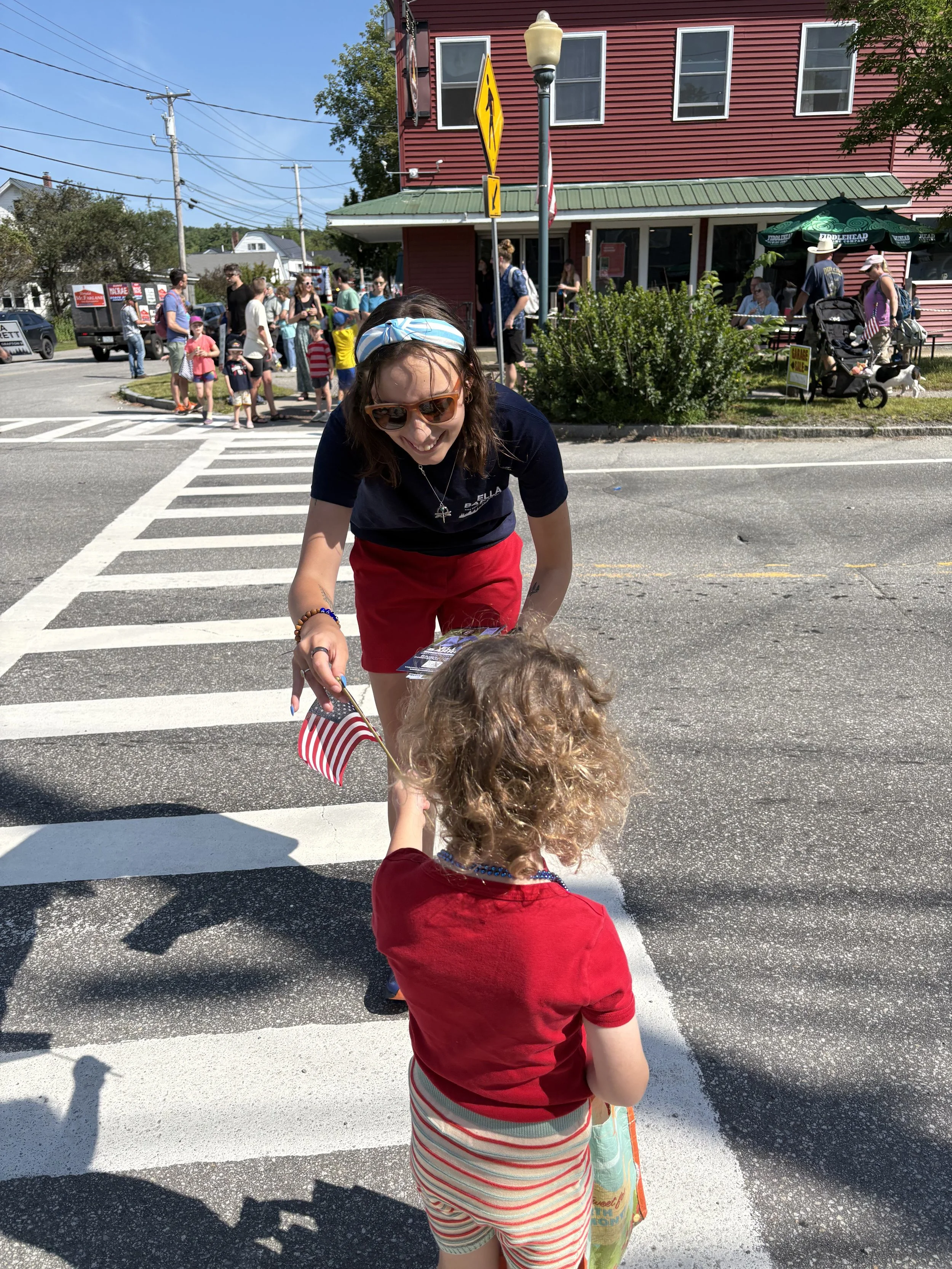 Handing out flags at Canaan's Old Home Days Parade