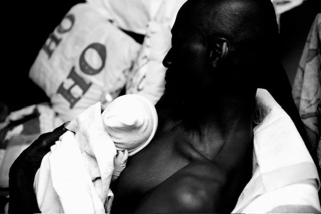 man skin to skin with newborn baby