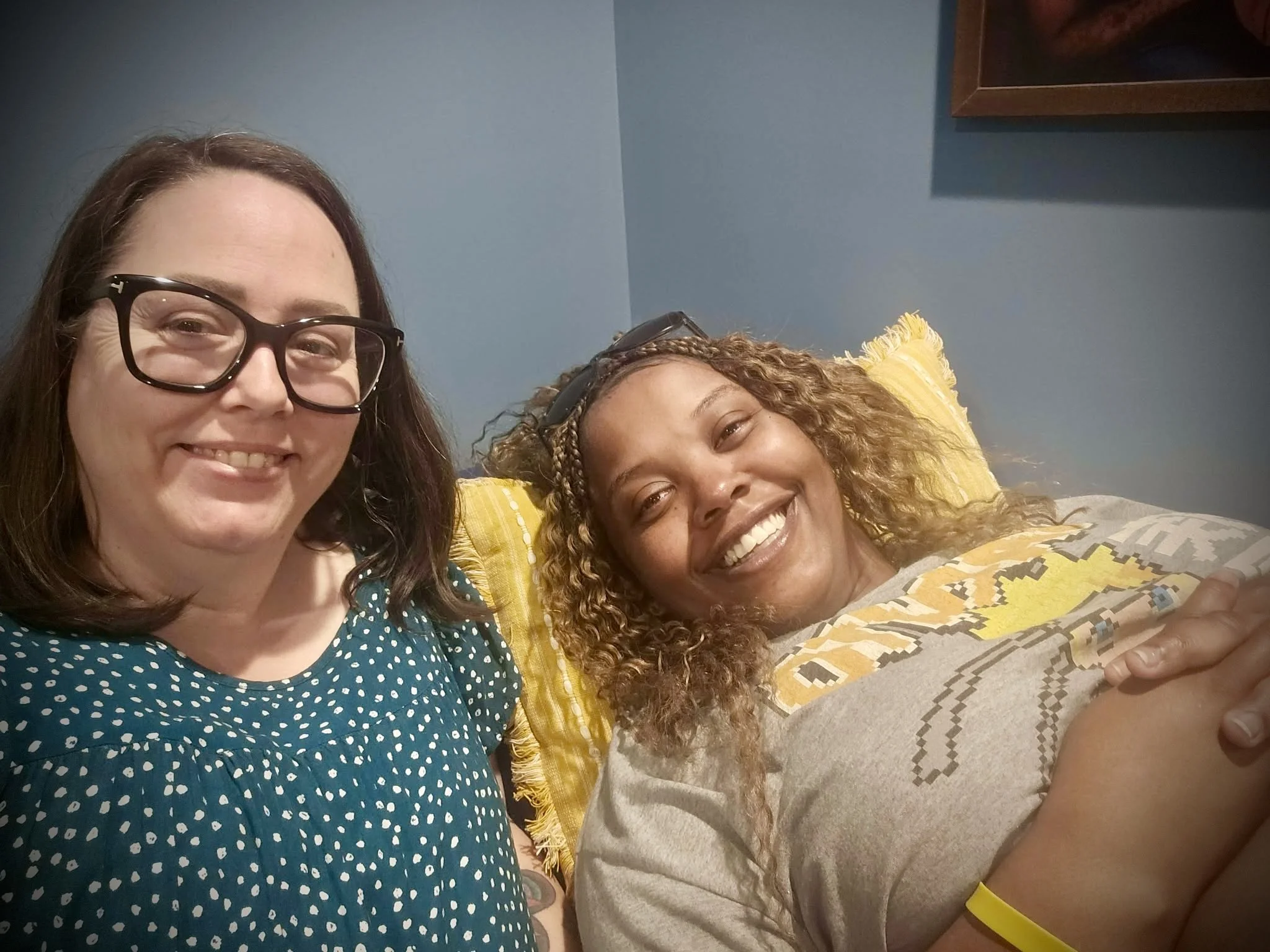 woman smiling with midwife at prenatal appointment 