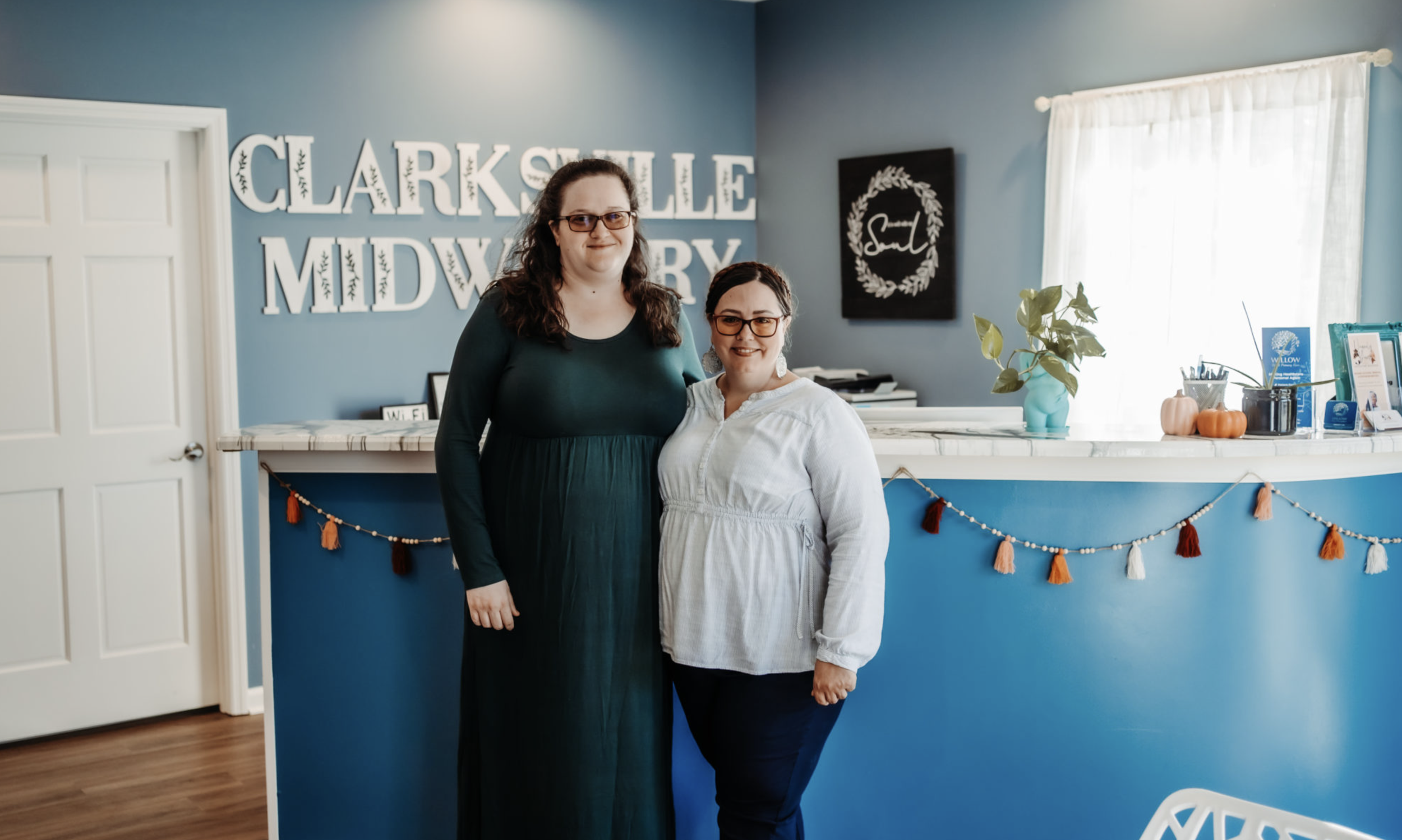 midwives at clarksville midwifery standing in front of front desk