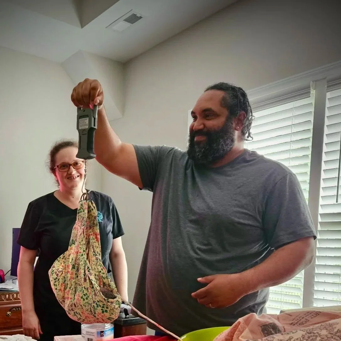 man weighing his baby