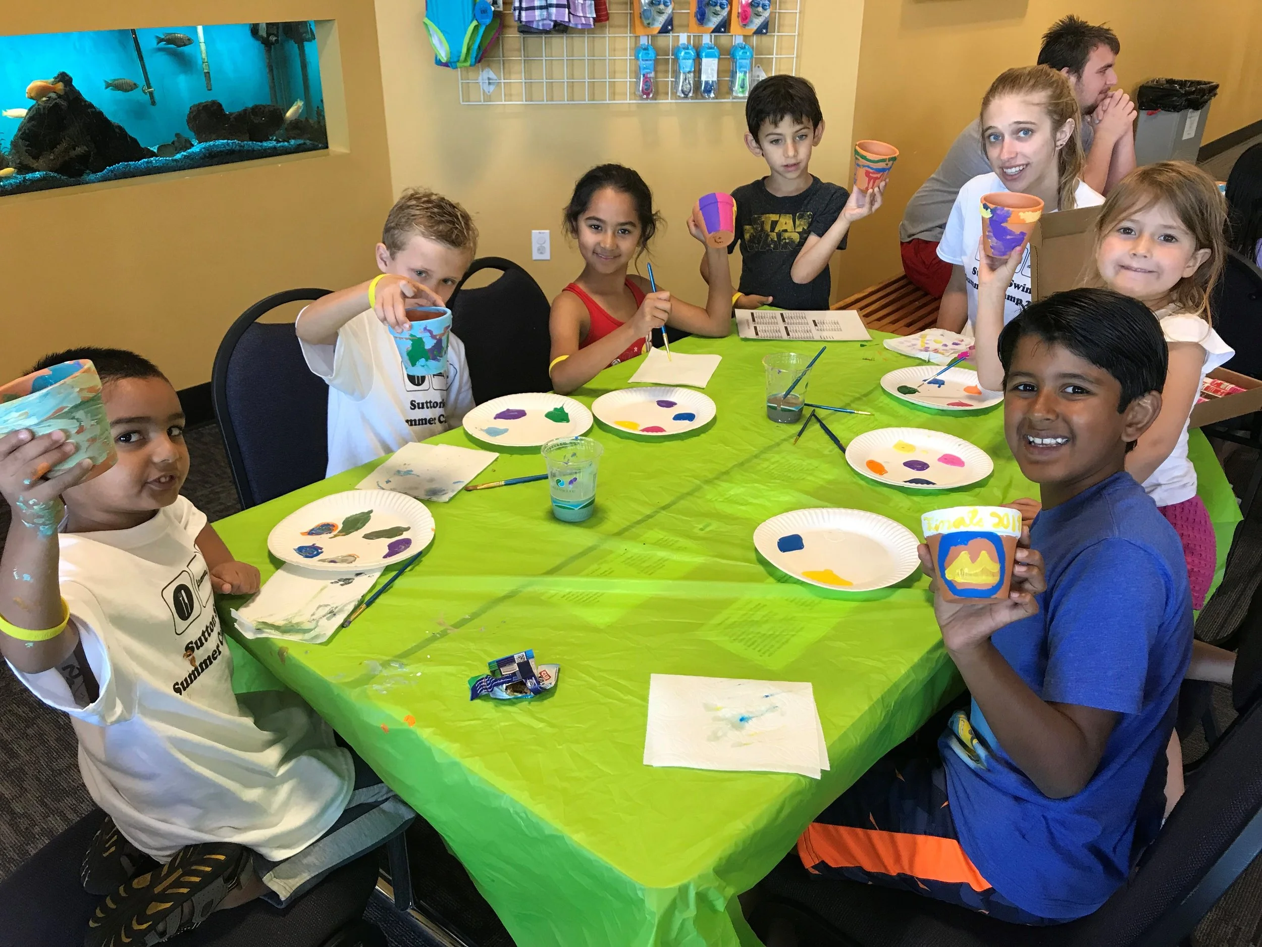 Kids doing crafts at a birthday party celebration