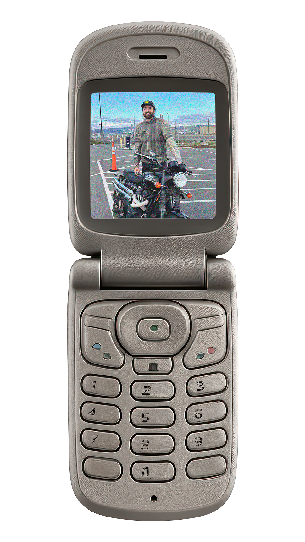 Early 2000's beige flip phone with an picture of Caleb standing behind his old motorcycle, a 2015 Triumph Scrambler