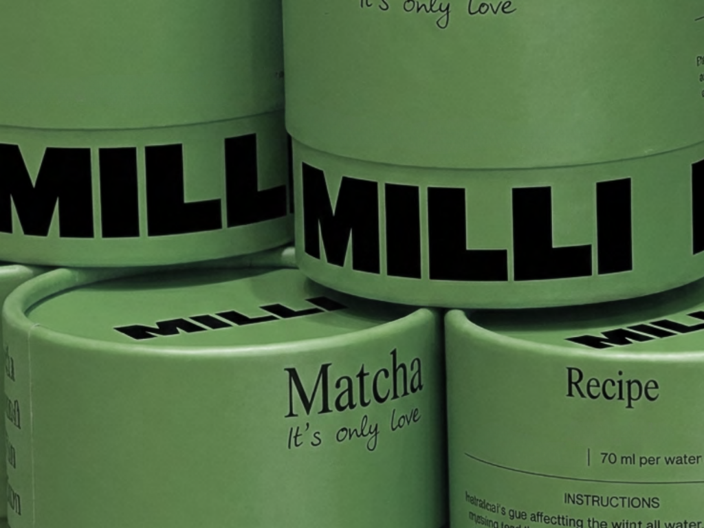 Three green containers of Millie Matcha, a matcha tea product, with the label 'Matcha It's only love' and 'Recipe' visible.
