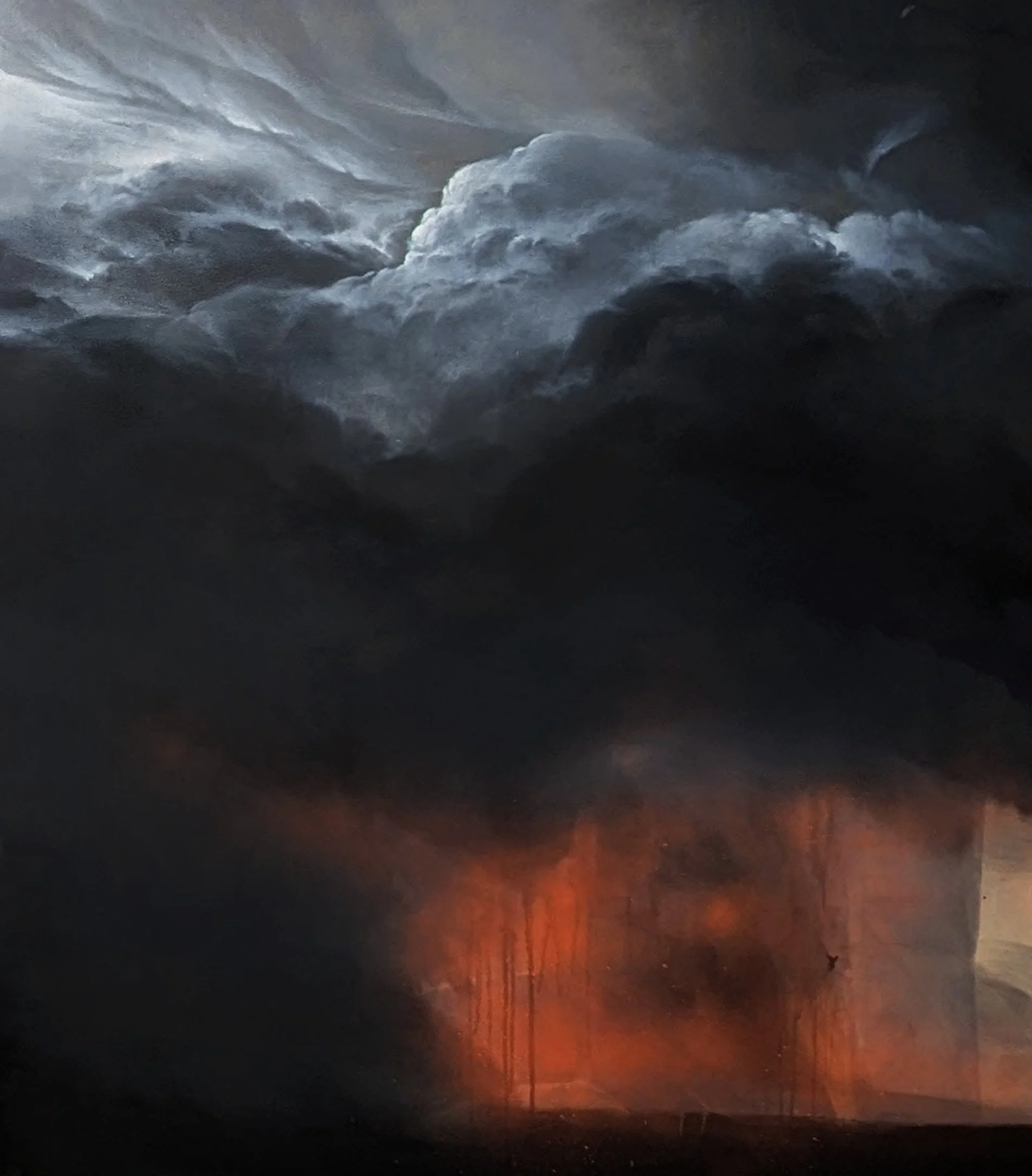 A stormy sky at sunset with dark clouds and a few visible lightning bolts over a flooded landscape with silhouettes of trees and utility poles.