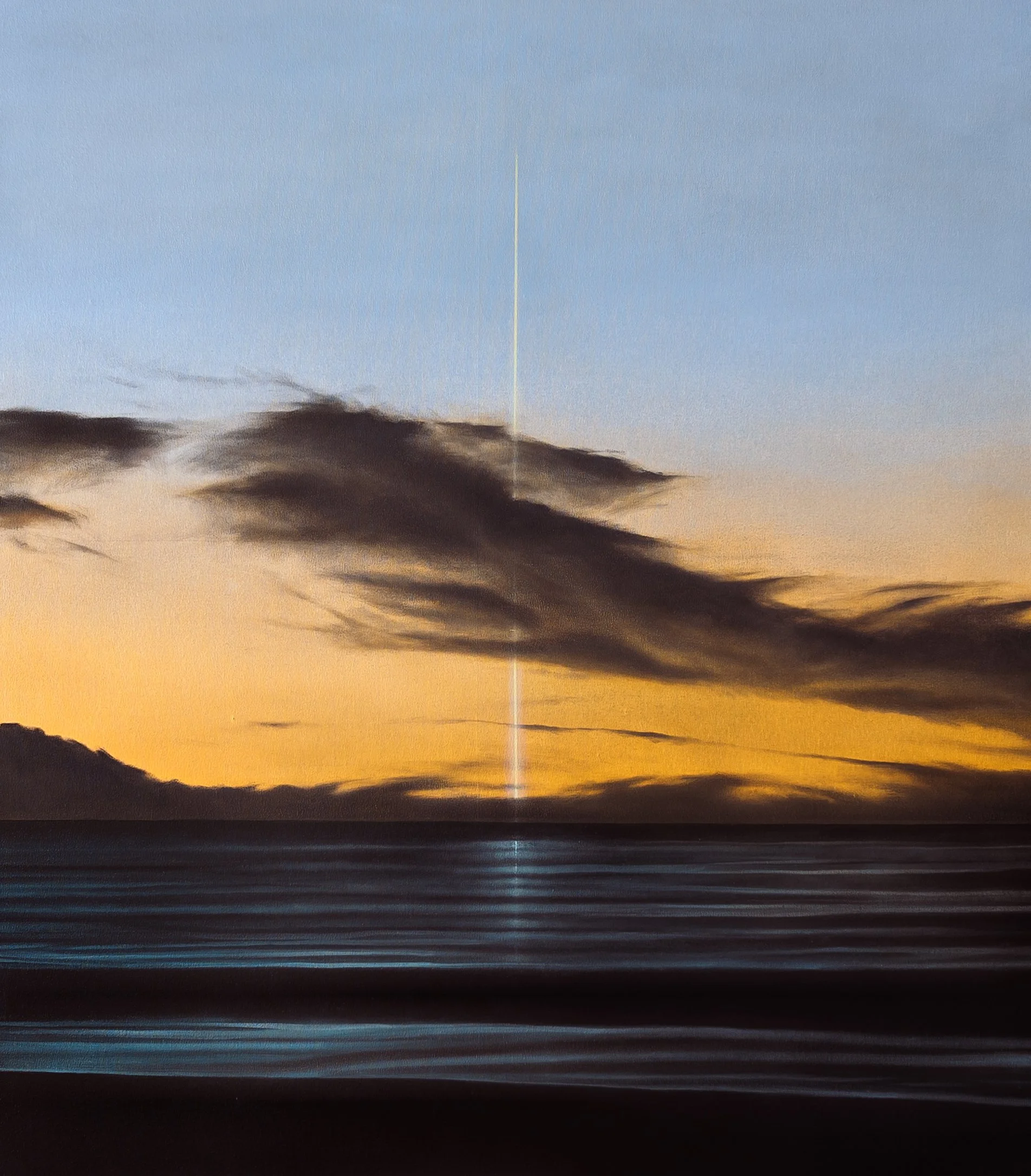 Sunset sky with dark clouds, blurred horizon, and a vertical bright light or beam in the center.