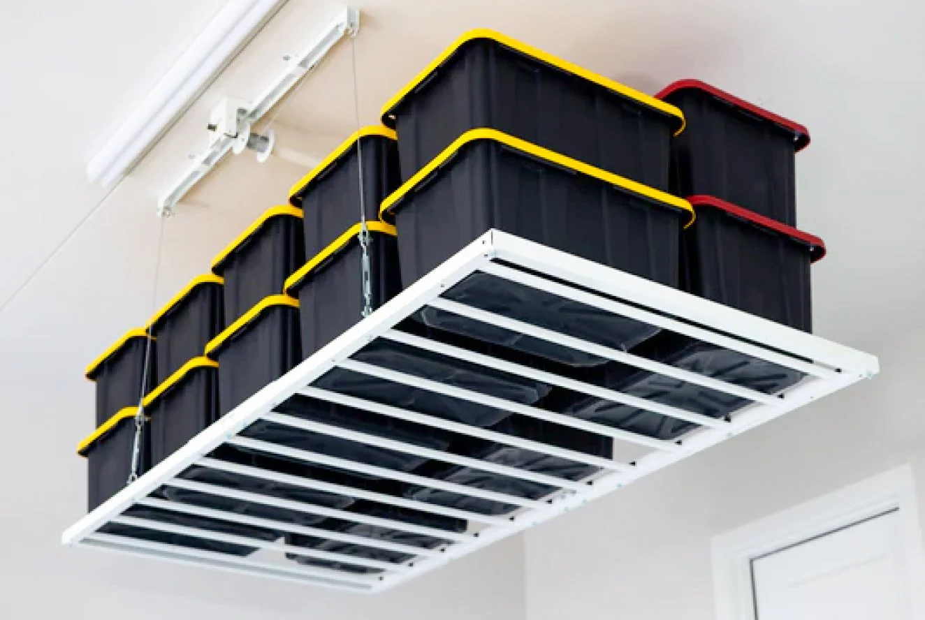 Hanging shelf with multiple large black storage bins with yellow and red lids.