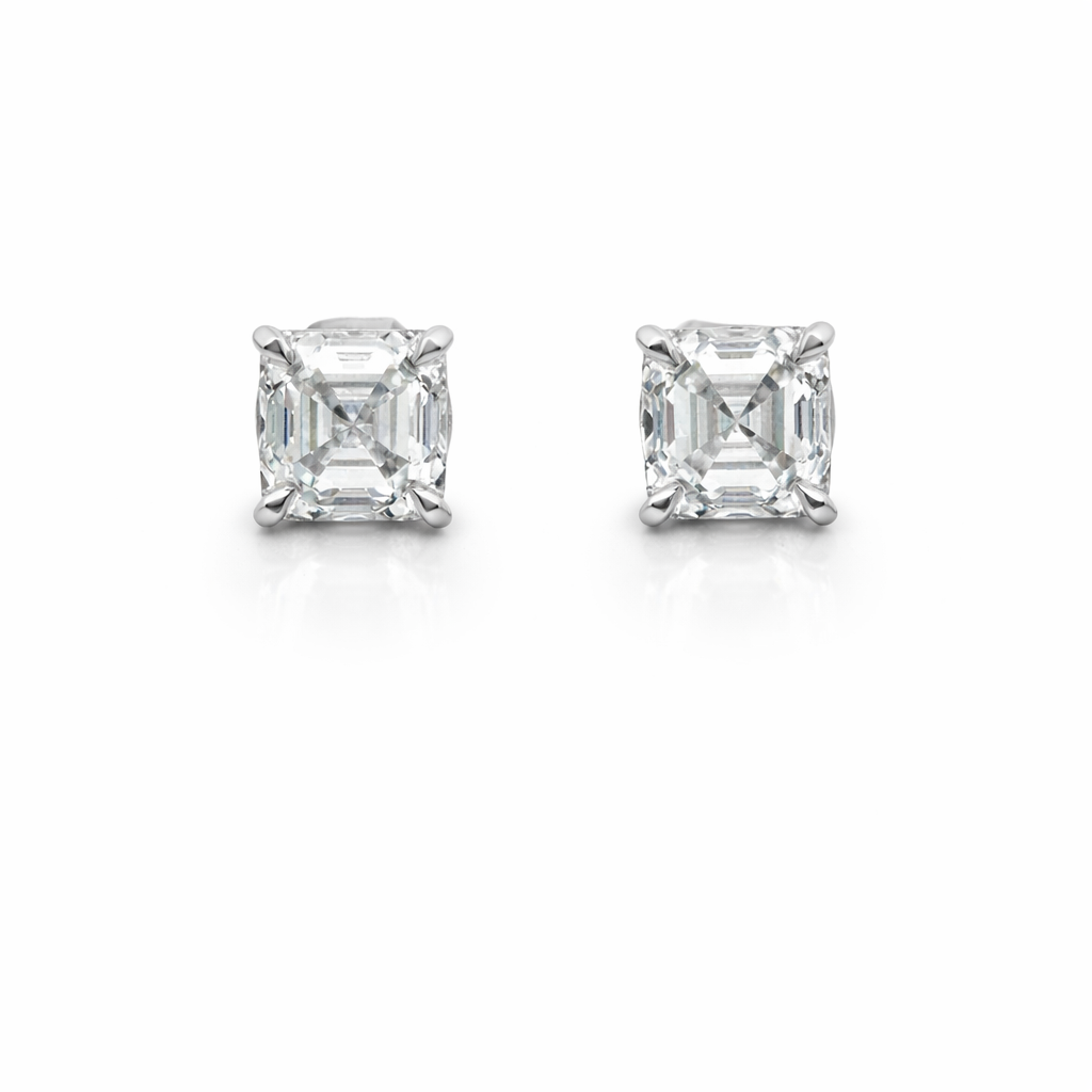 Pair of diamond stud earrings on a white background.