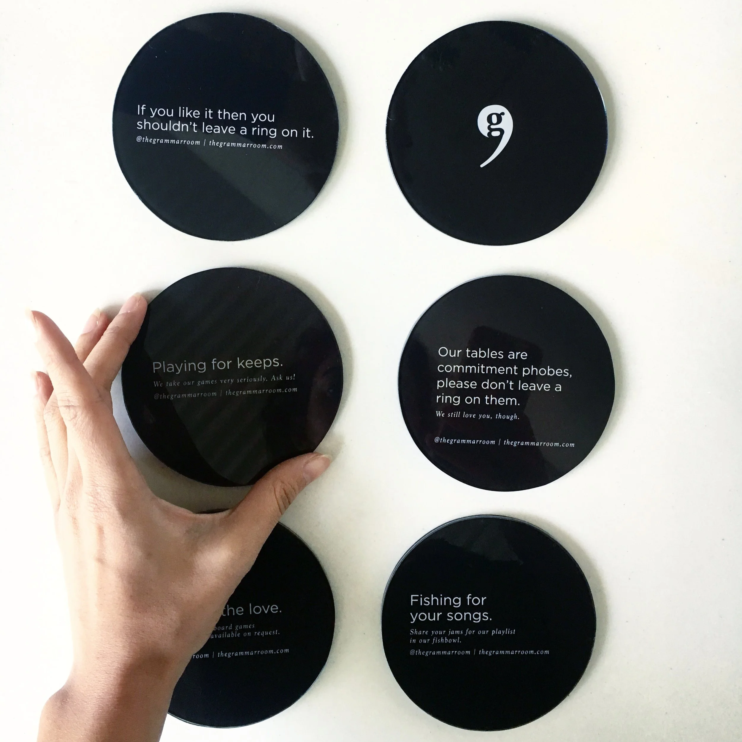Coasters from The Grammar Room designed by 31-12 Studio and Tanya Bhardwaj "If you like it then you shouldn't leave a ring on it," and includes a website URL, thegrammarrroom.com.