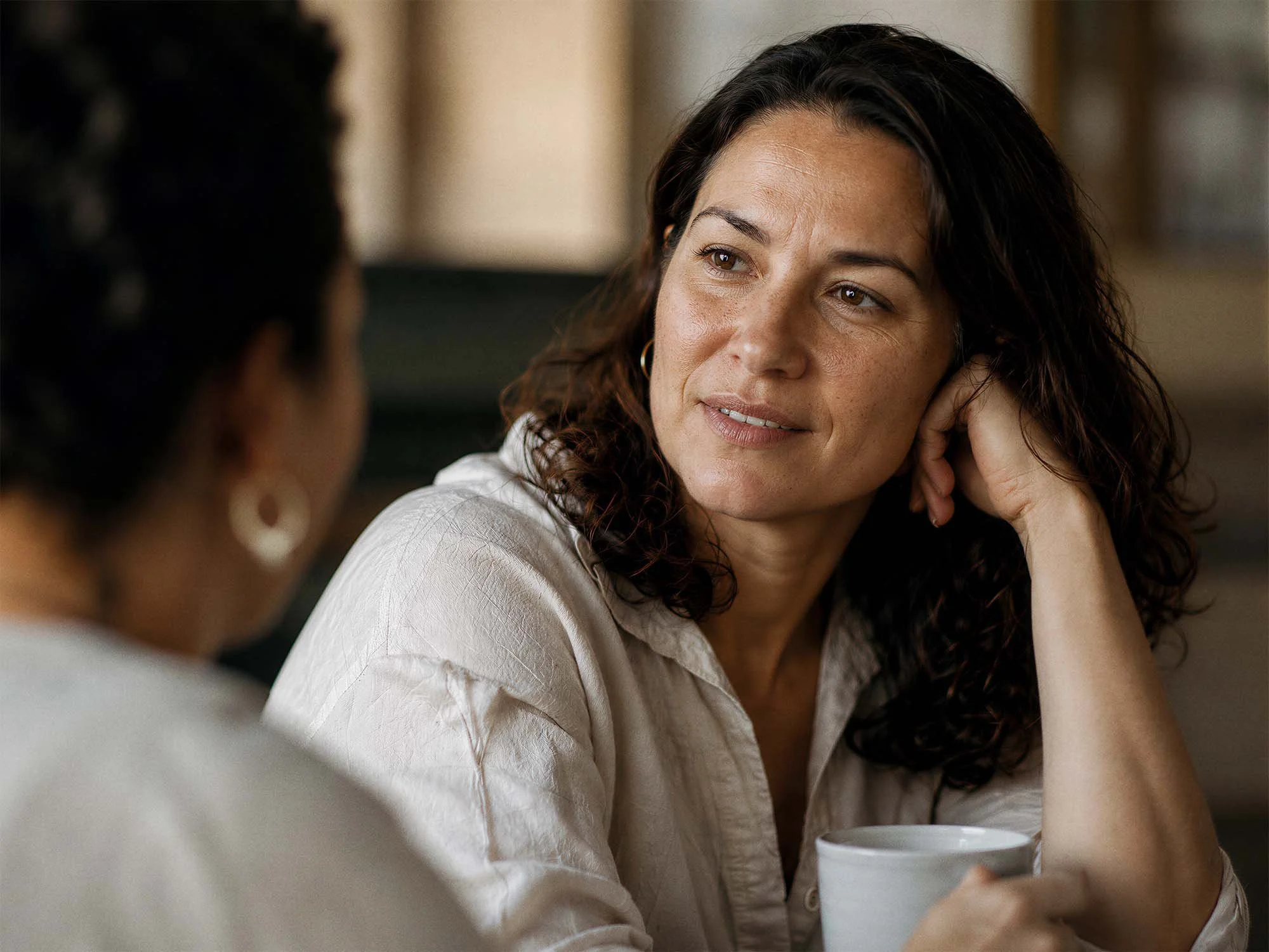 Woman listening attentively during a consultation for routine care, assessments, and general wellbeing support.