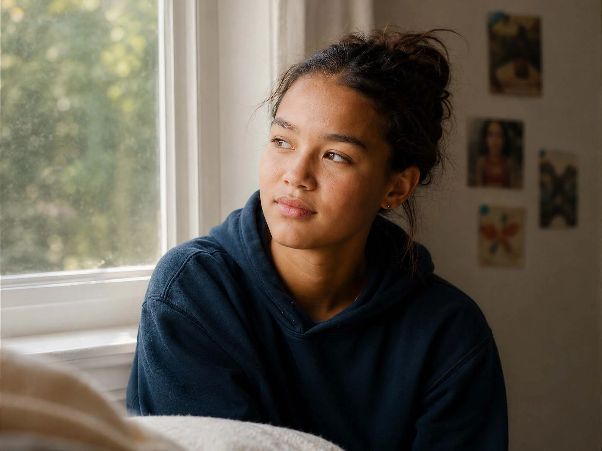 A young woman looking out a window. Complete Women's Health provides confidential, respectful care and ongoing support for sexual health concerns.