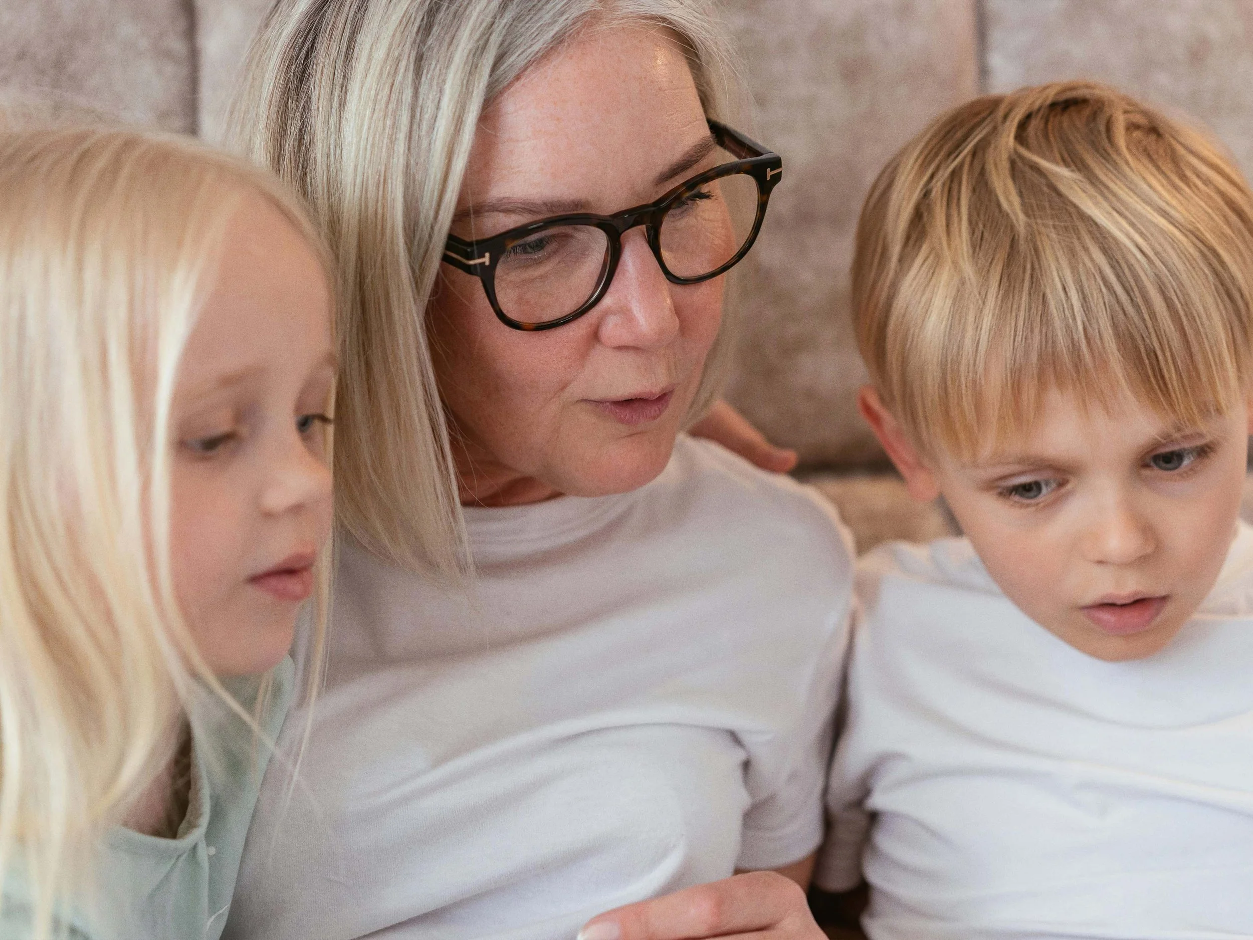 Woman sitting with two children. Complete Women's Health provides routine healthcare and support for women at all life stages in the Hutt and Wellington region.