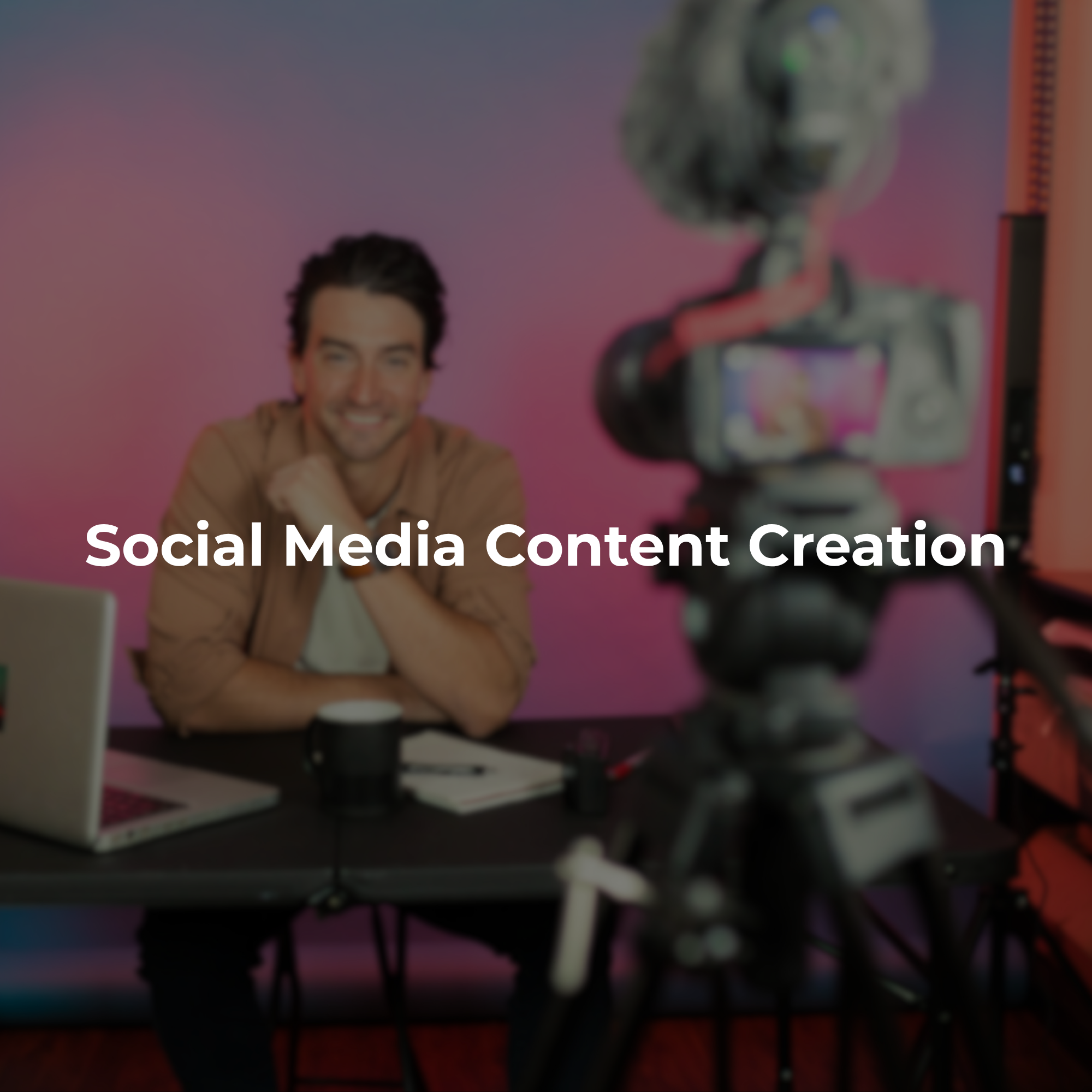Social media content production setup with a creator recording video at a desk with a laptop and microphone in a studio.