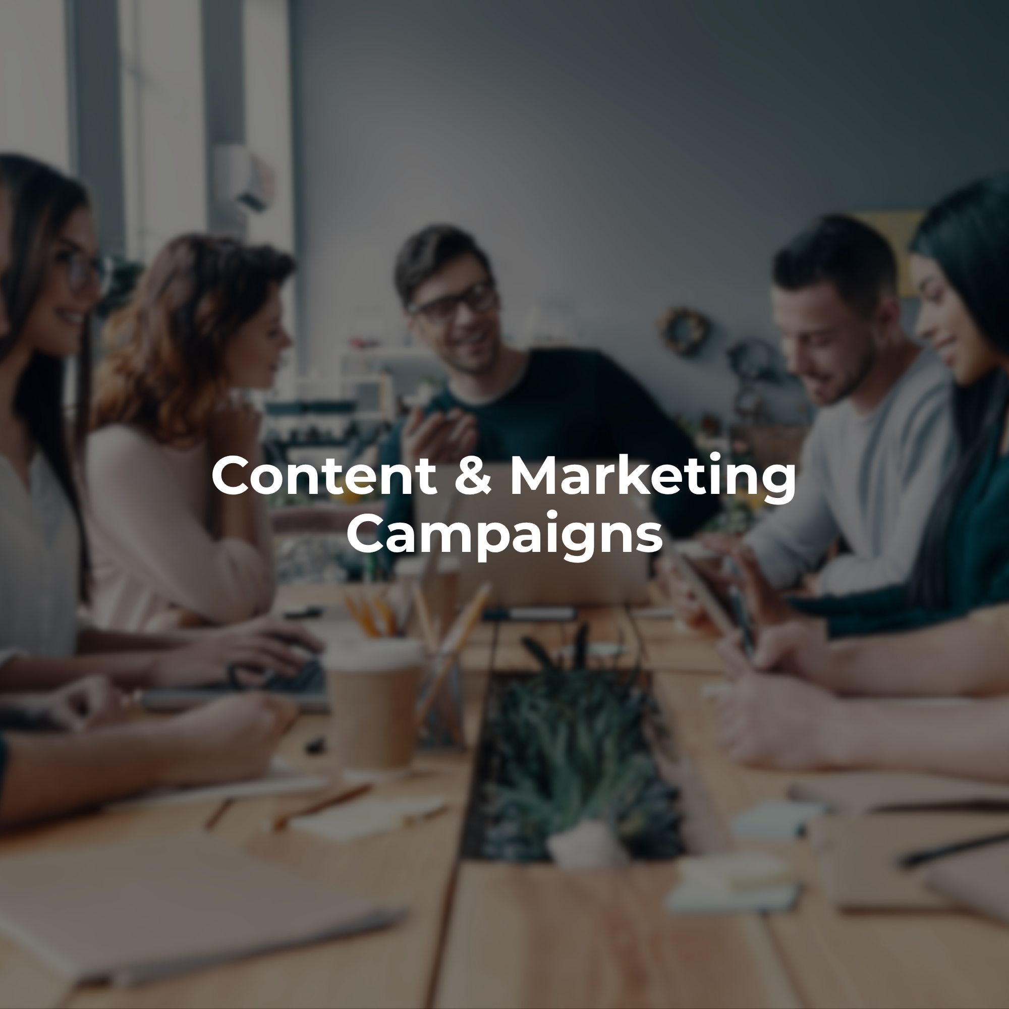 Creative team collaborating around a table to plan content and marketing campaigns.
