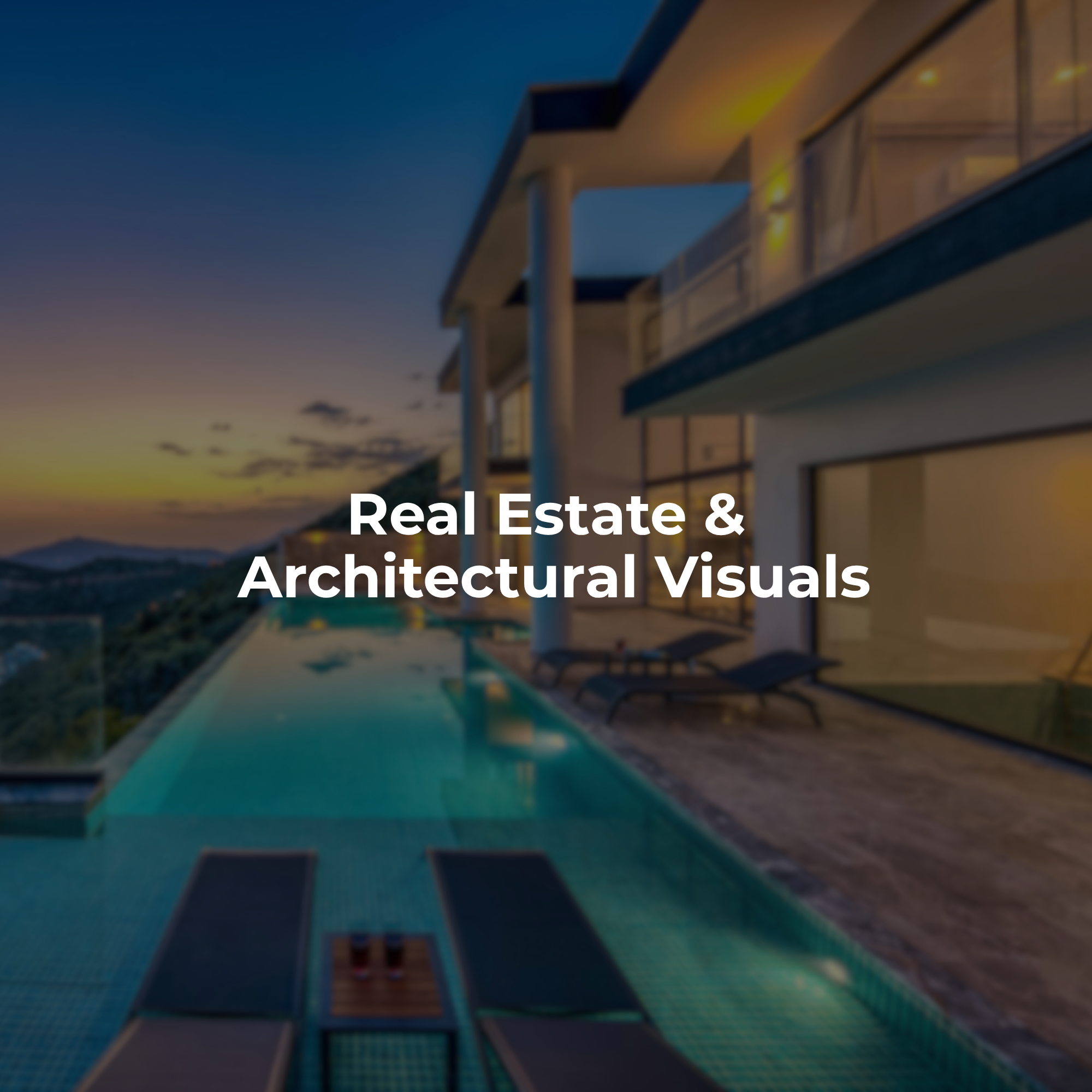 Modern architectural property with large glass windows and balcony surrounded by a mountainous landscape at sunset.