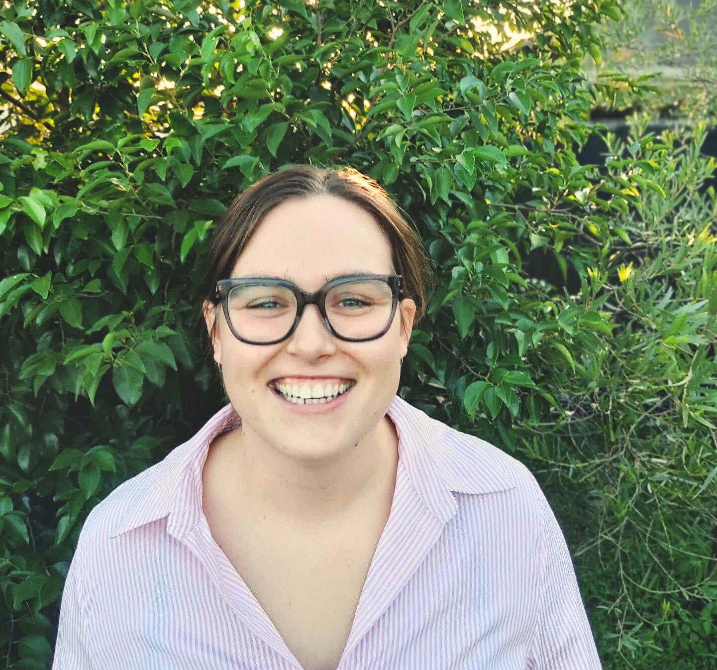 Claudia Giesen smiling in a natural light portrait — counsellor at Whispering Hope Therapy