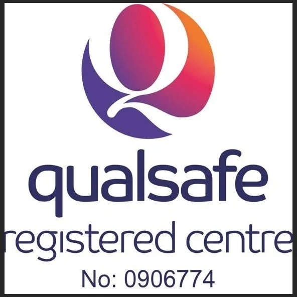 Logo of Qualsafe registered center with a stylized purple and orange shape and the registration number 0906774.