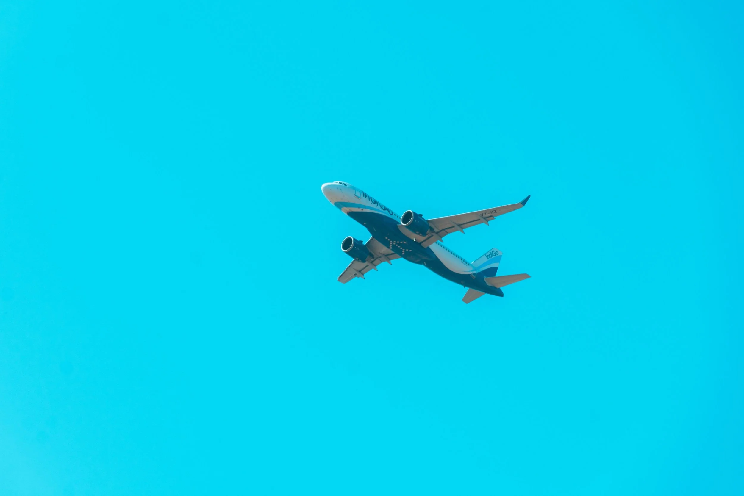 A commercial airplane flying in a clear blue sky during daytime.