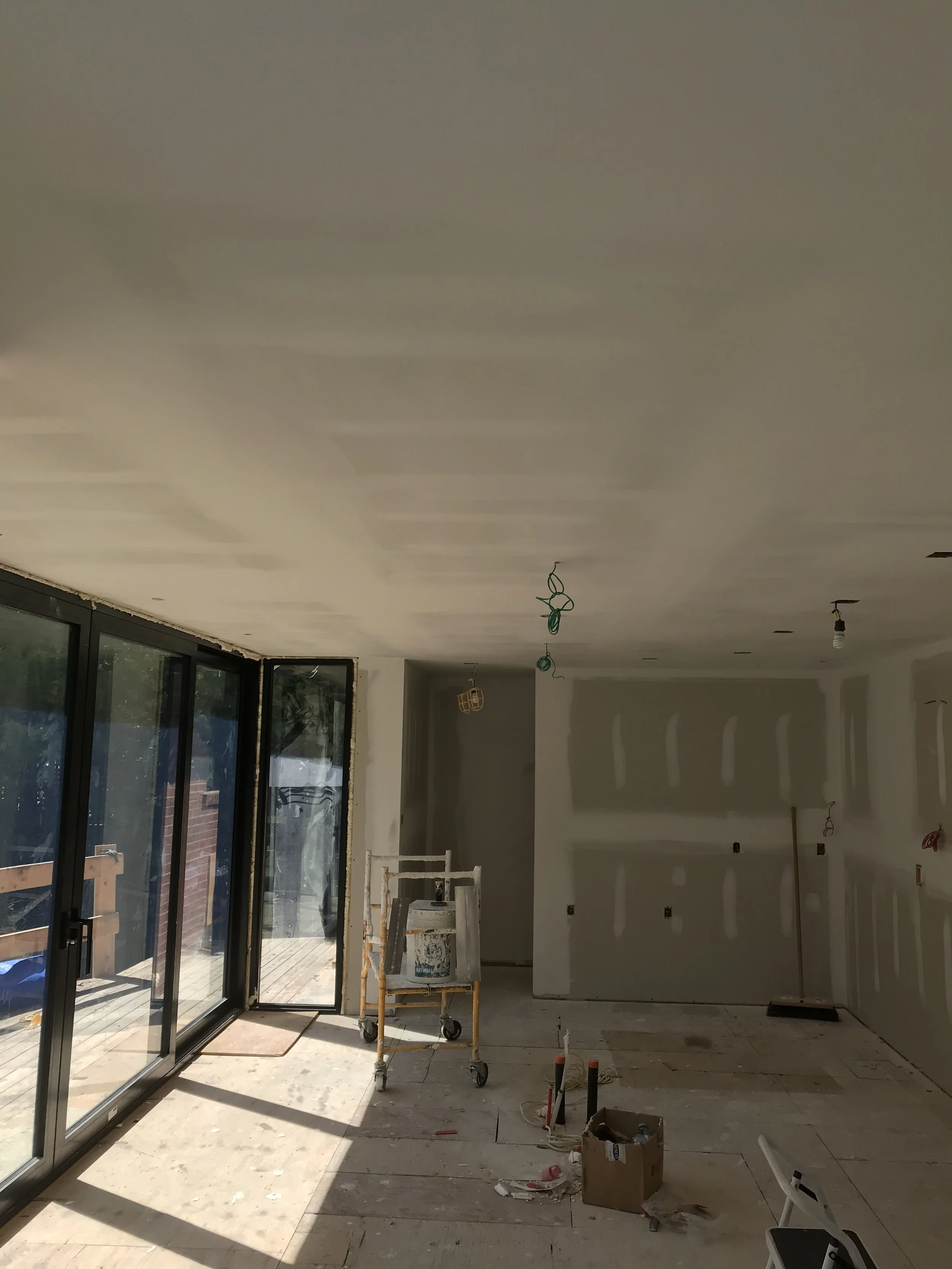 Drywall finishing and taping project for a custom home renovation in Oakville.