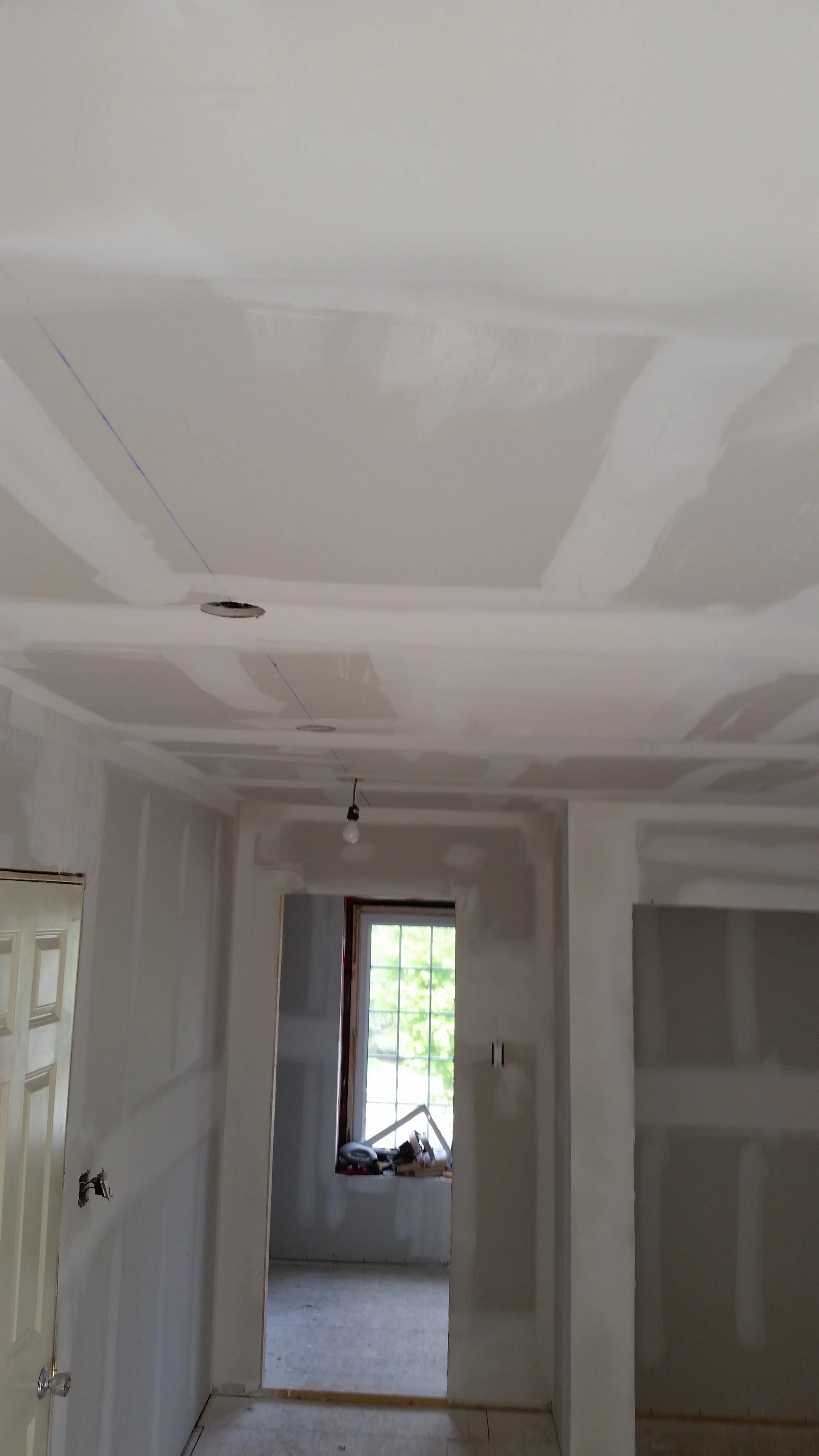 Ceiling repair and drywall finishing project during a residential renovation in Oakville.