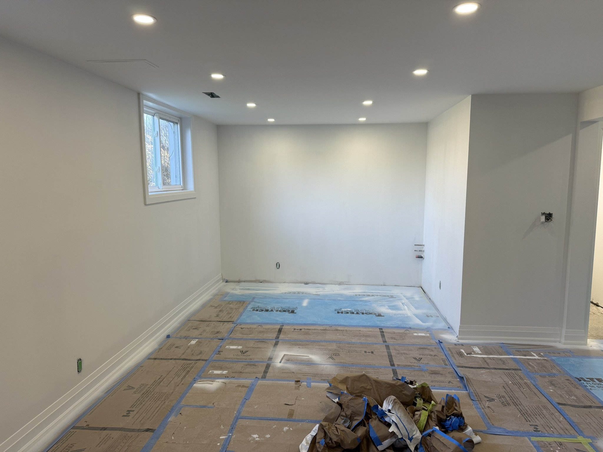 A basement in Mississauga under construction with new drywall installed and taped.