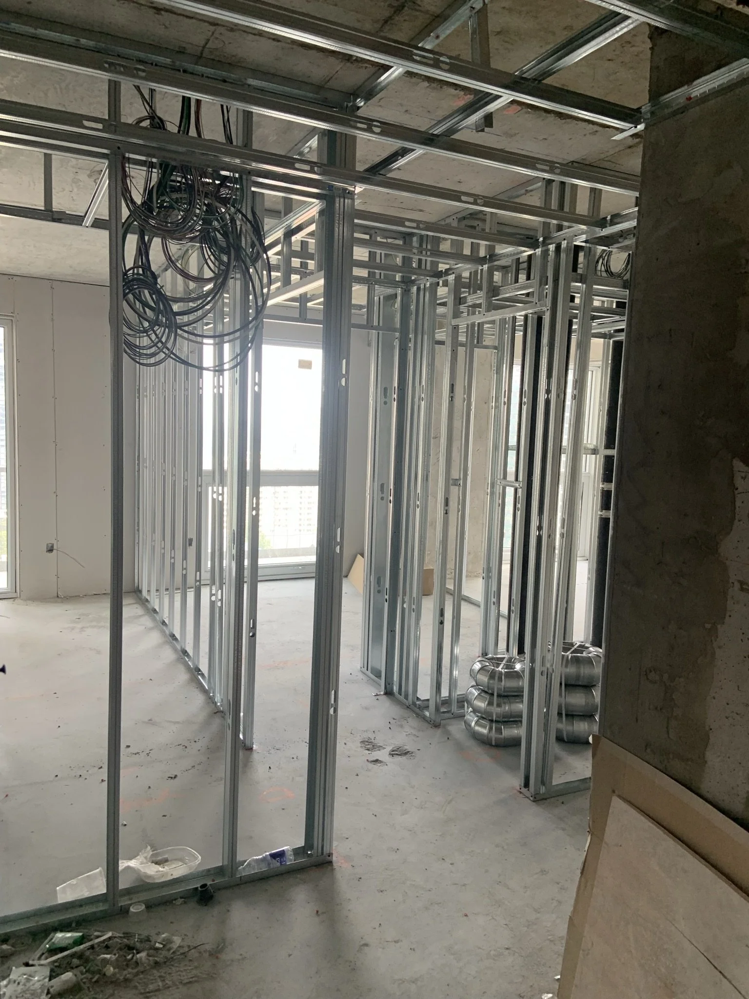 Commercial metal stud framing and drywall preparation completed in a Toronto condo unit.