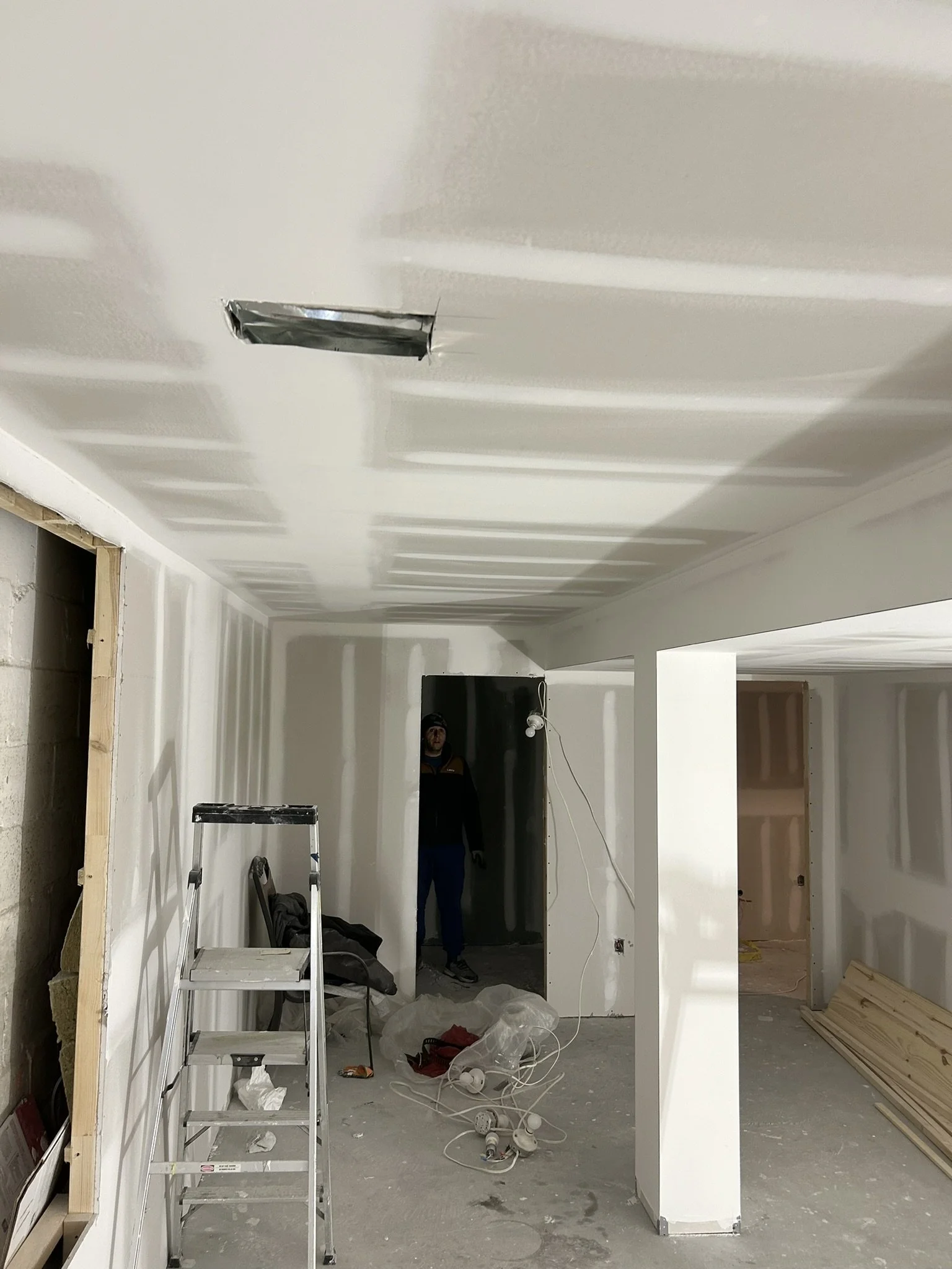 Drywall installation and plastering during a home renovation in Toronto.