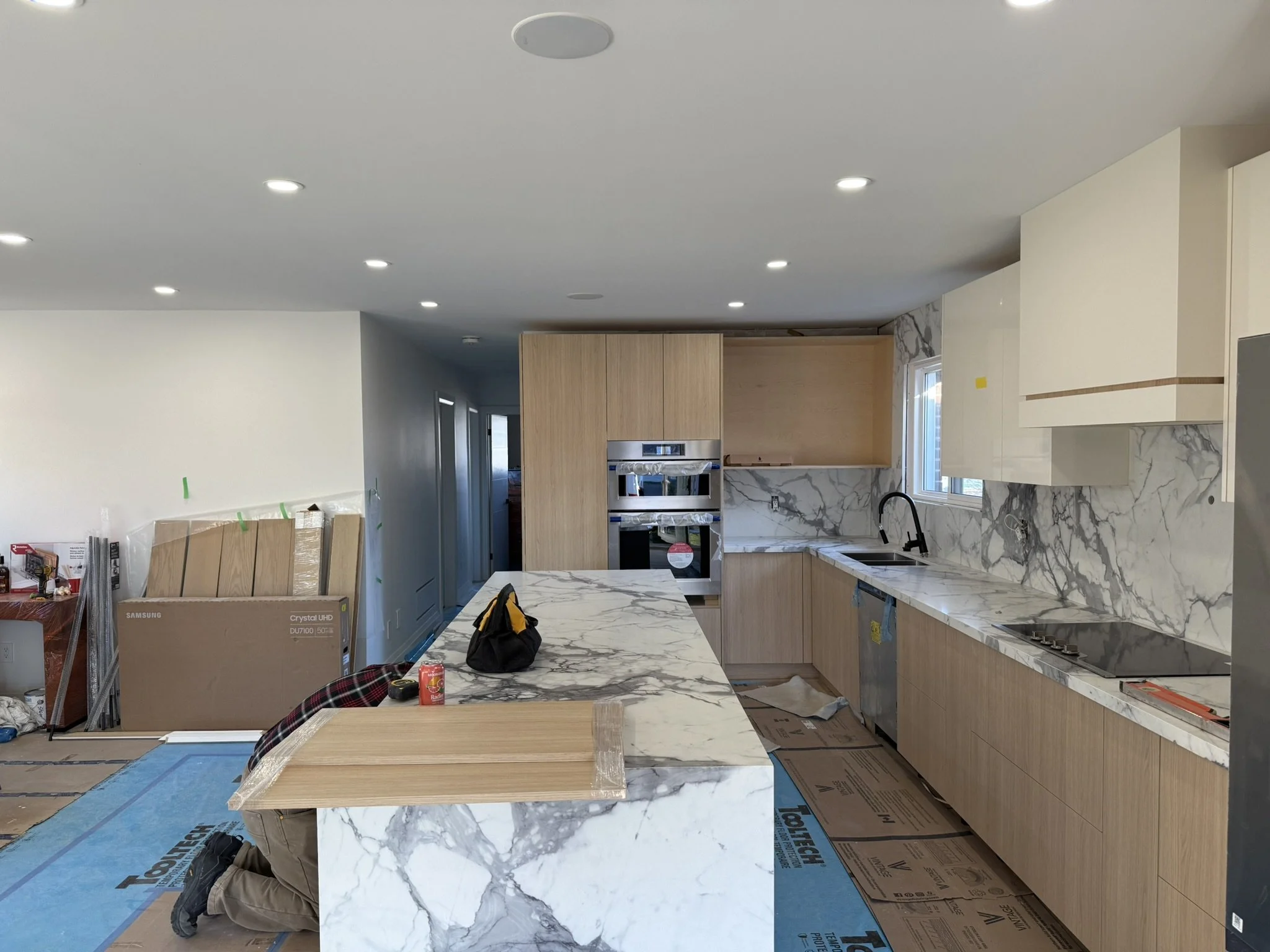 Kitchen in Mississauga under construction, with drywall installation done and joints taped.