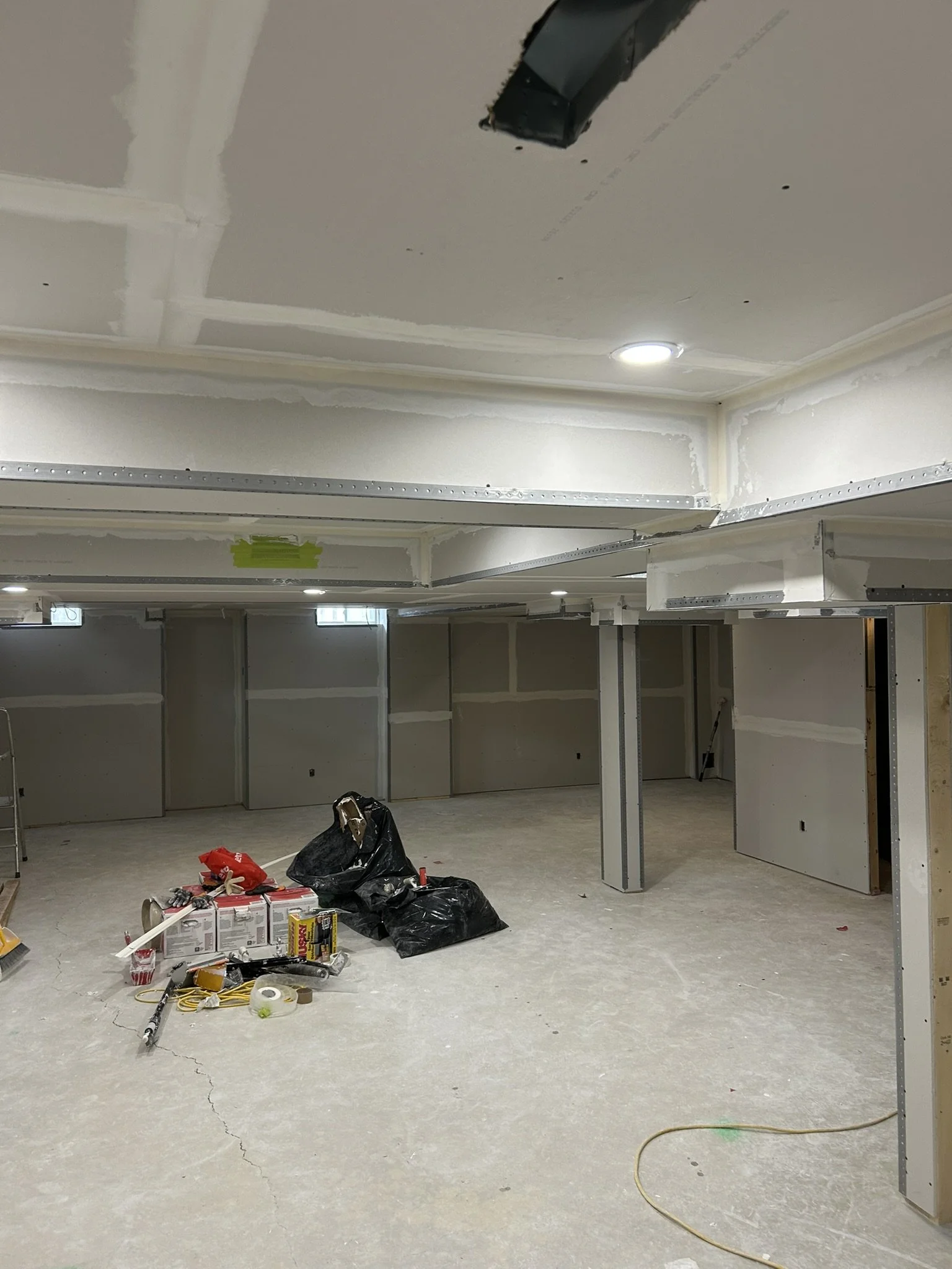 Basement drywall installation and taping project in Oakville.