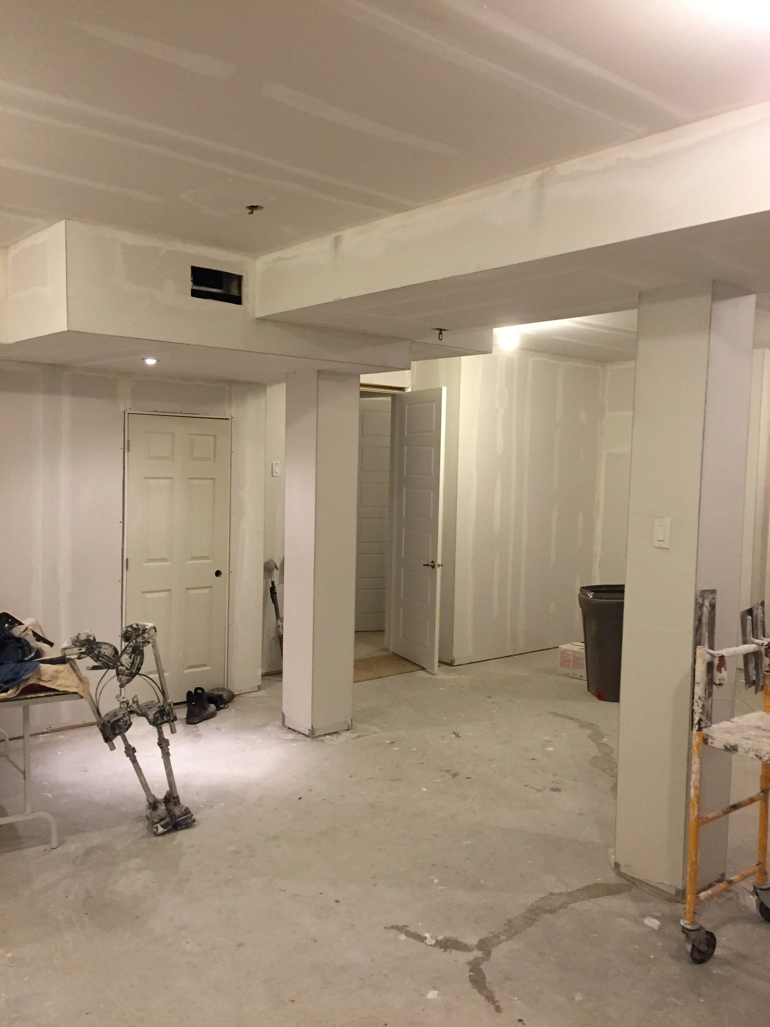 Residential basement renovation with drywall installation and taping in Toronto.