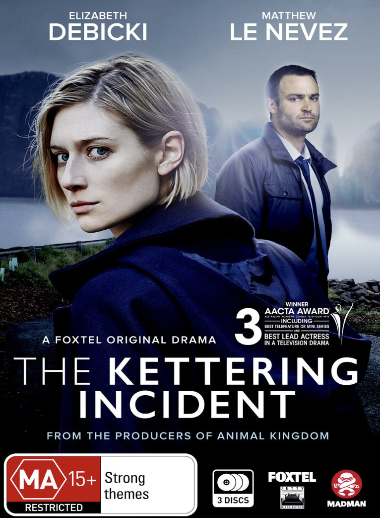 Promotional poster for the TV series 'The Kettering Incident' featuring actress Elizabeth Debicki and actor Matthew Le Nevez. The background shows a landscape with mountains, water, and a cloudy sky. The poster includes text about awards and content ratings.