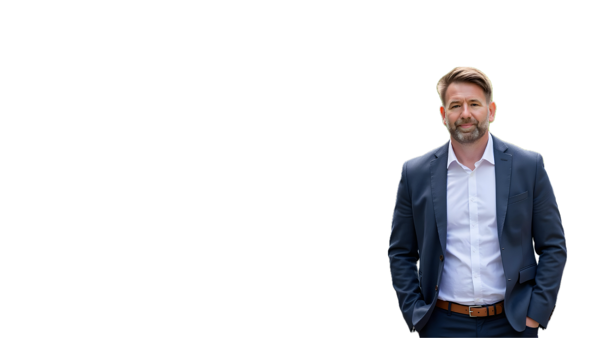 Man in business suit standing outdoors, wearing a dark blue blazer and white shirt, with his right hand in his pocket, smiling slightly.
