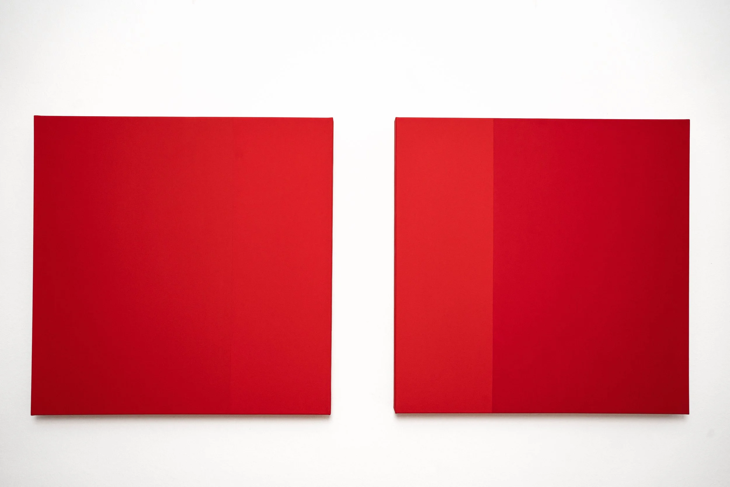Two red square tiles placed side by side on a white background.