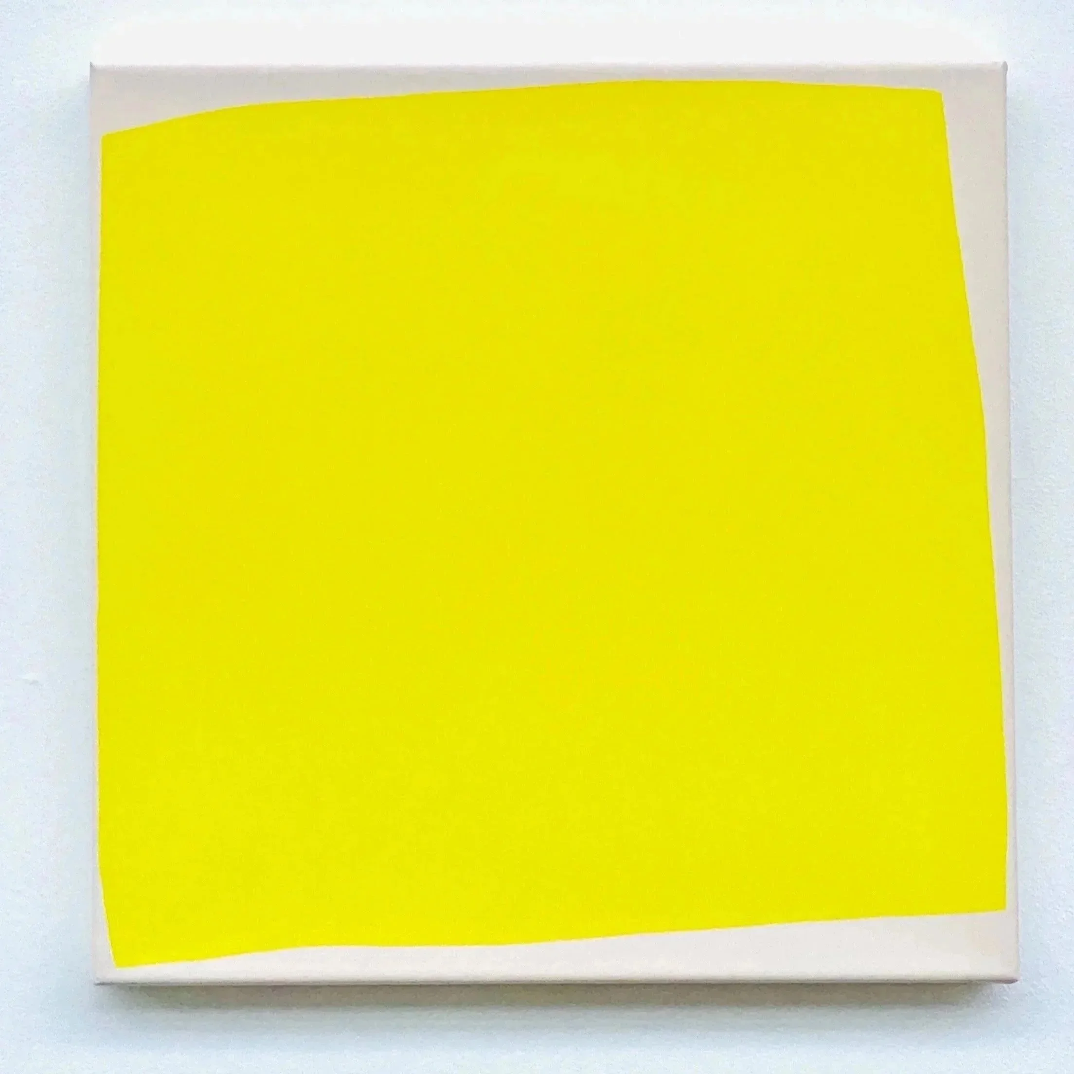 Close-up of a yellow sticky note on white paper.