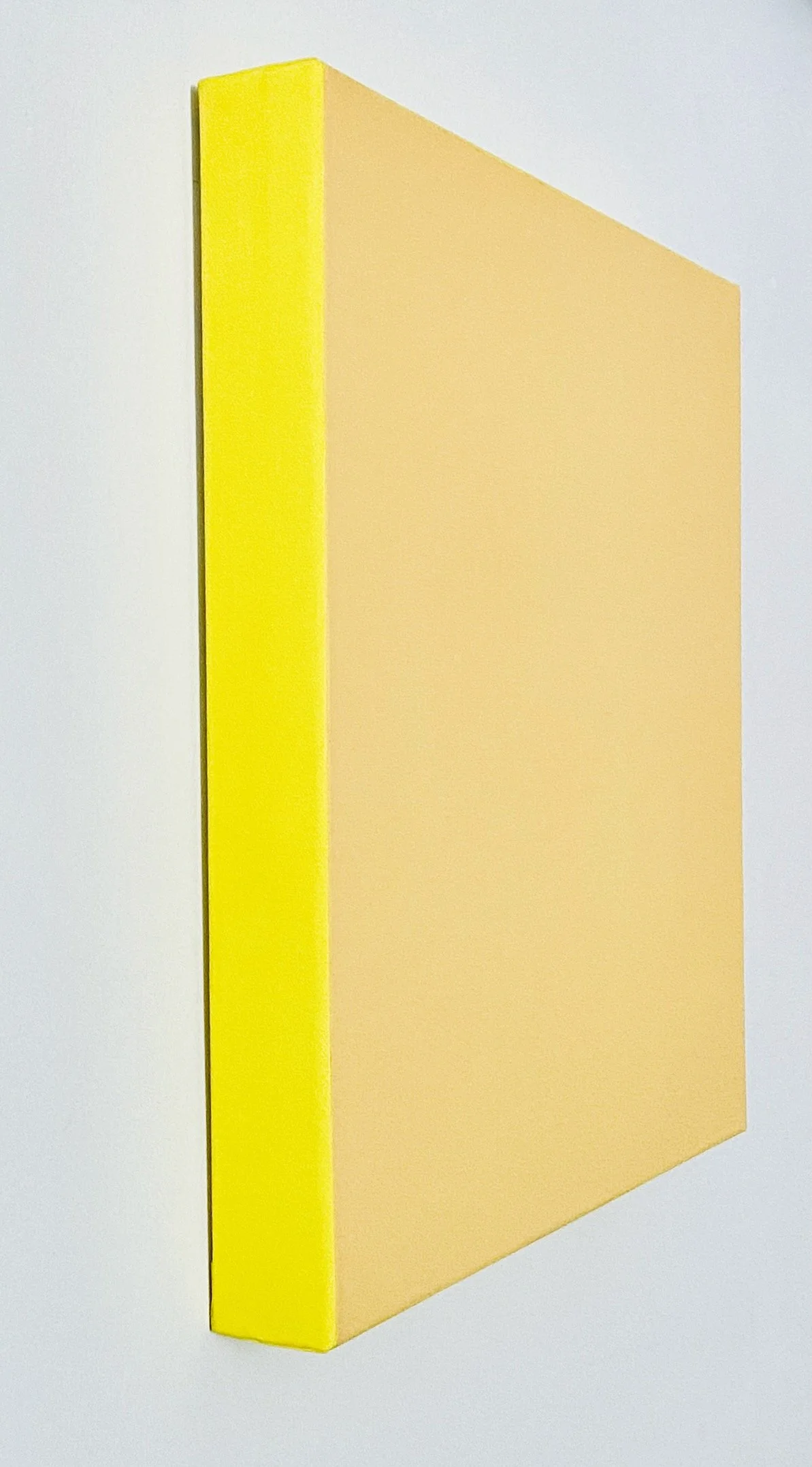 Yellow and peach foam pool float with a rectangular shape and rounded edges, set against a plain white background.
