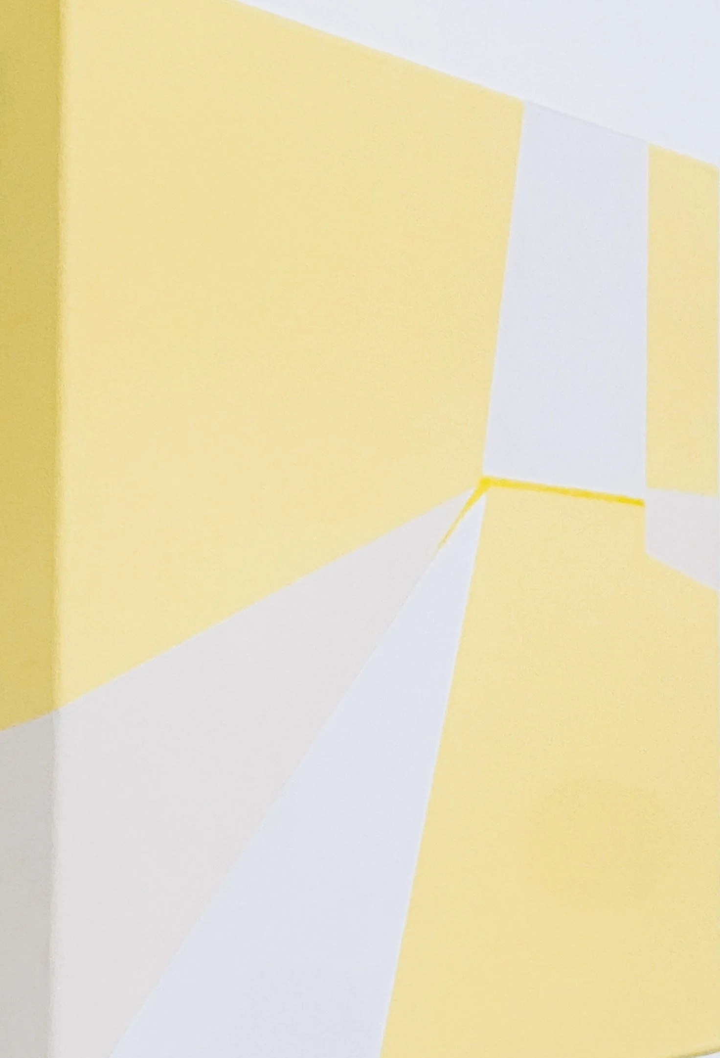 A hallway with yellow walls and white ceiling, with white baseboards and yellow accents on the walls.