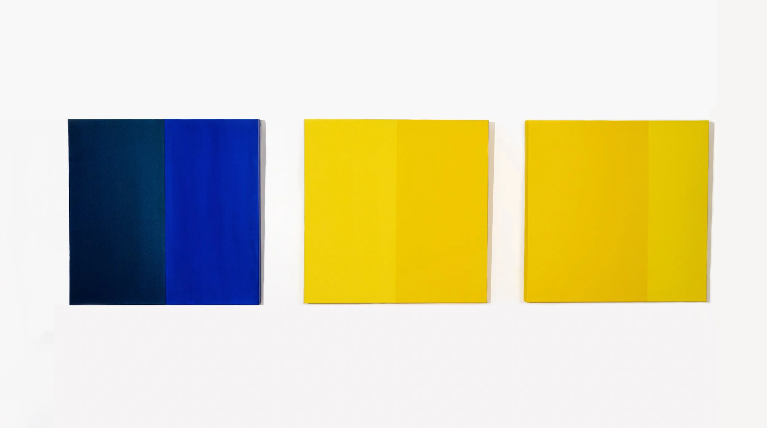 Three rectangular panels – one dark blue, one yellow, and one light yellow – are displayed against a white background.