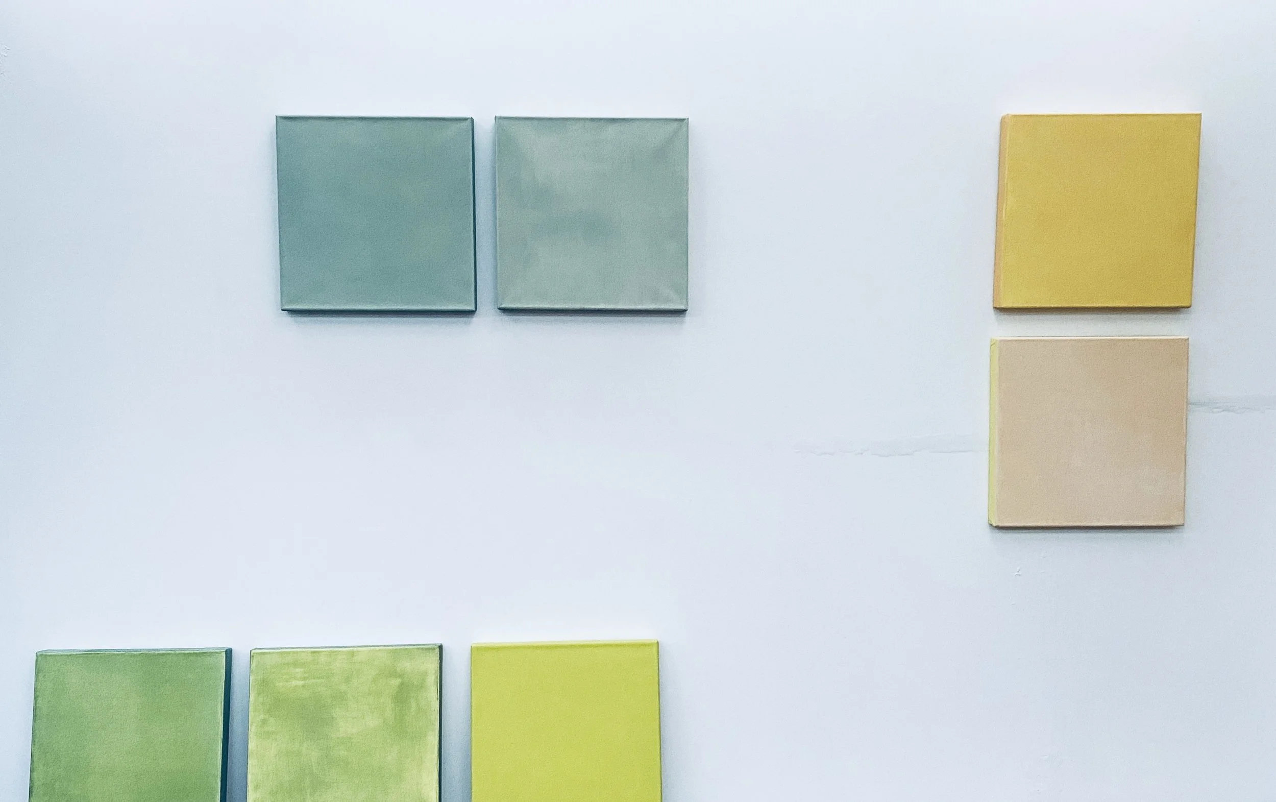 Color swatches arranged on a white background, with blue shades at the top, yellow and beige shades on the right, and green shades at the bottom.