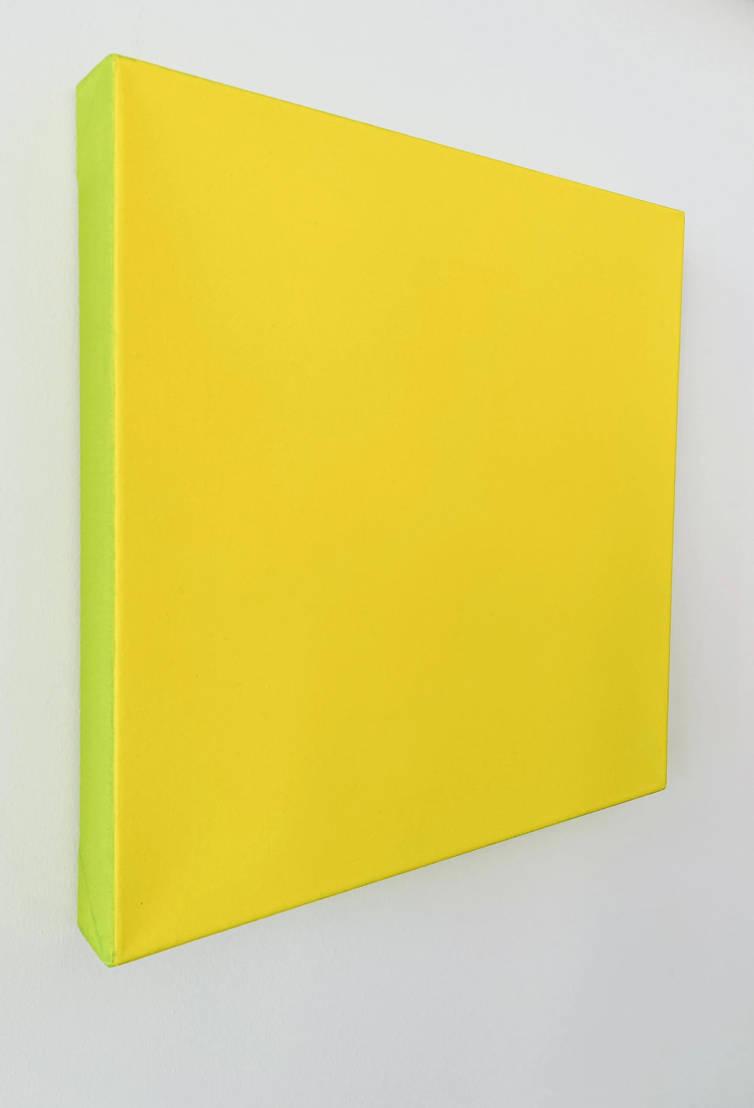 A yellow rectangular 3D object with green sides, set against a plain white background.